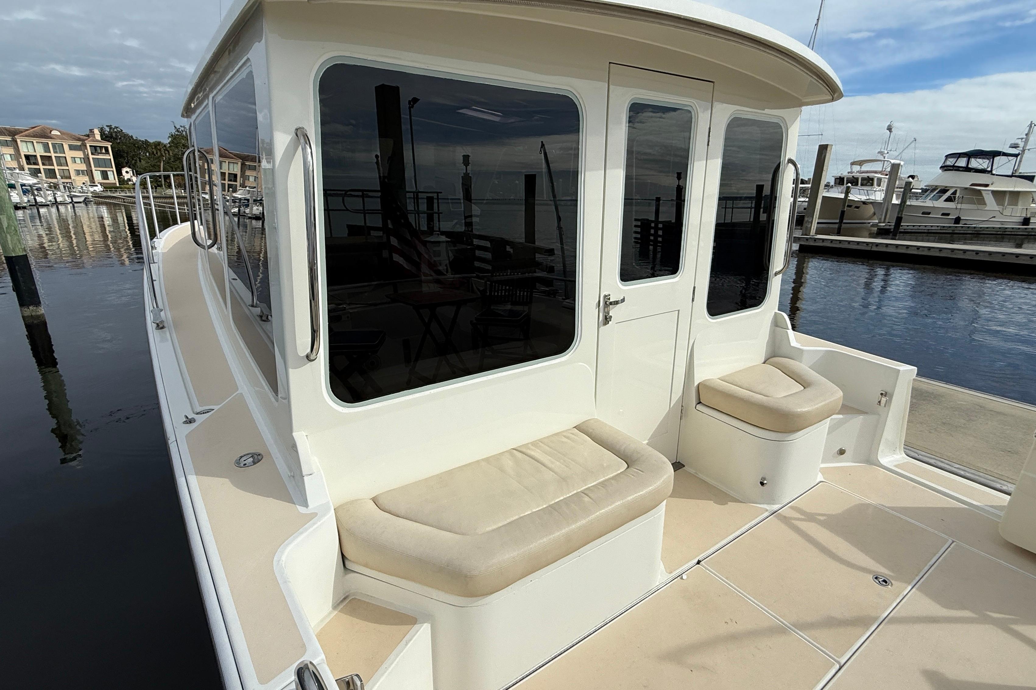 2012 MJM 40z yacht at marina, featuring cushioned seating and sleek design.