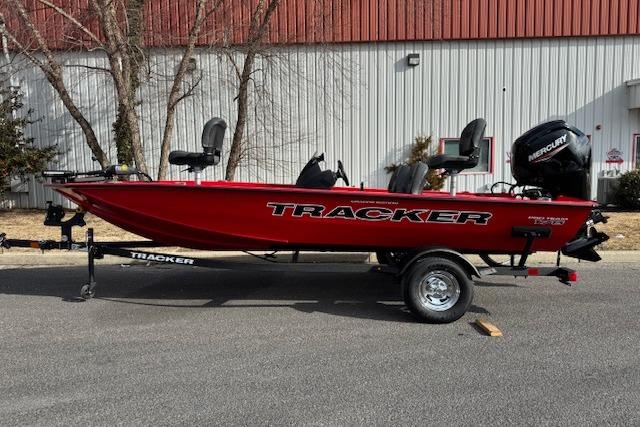 2026 Tracker Pro Team 175 Crappie Edition boat, red, on trailer, parked outdoors.