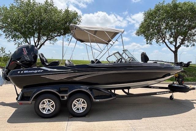 2026 Ranger 212LS boat with canopy on trailer, parked outdoors under clear sky.