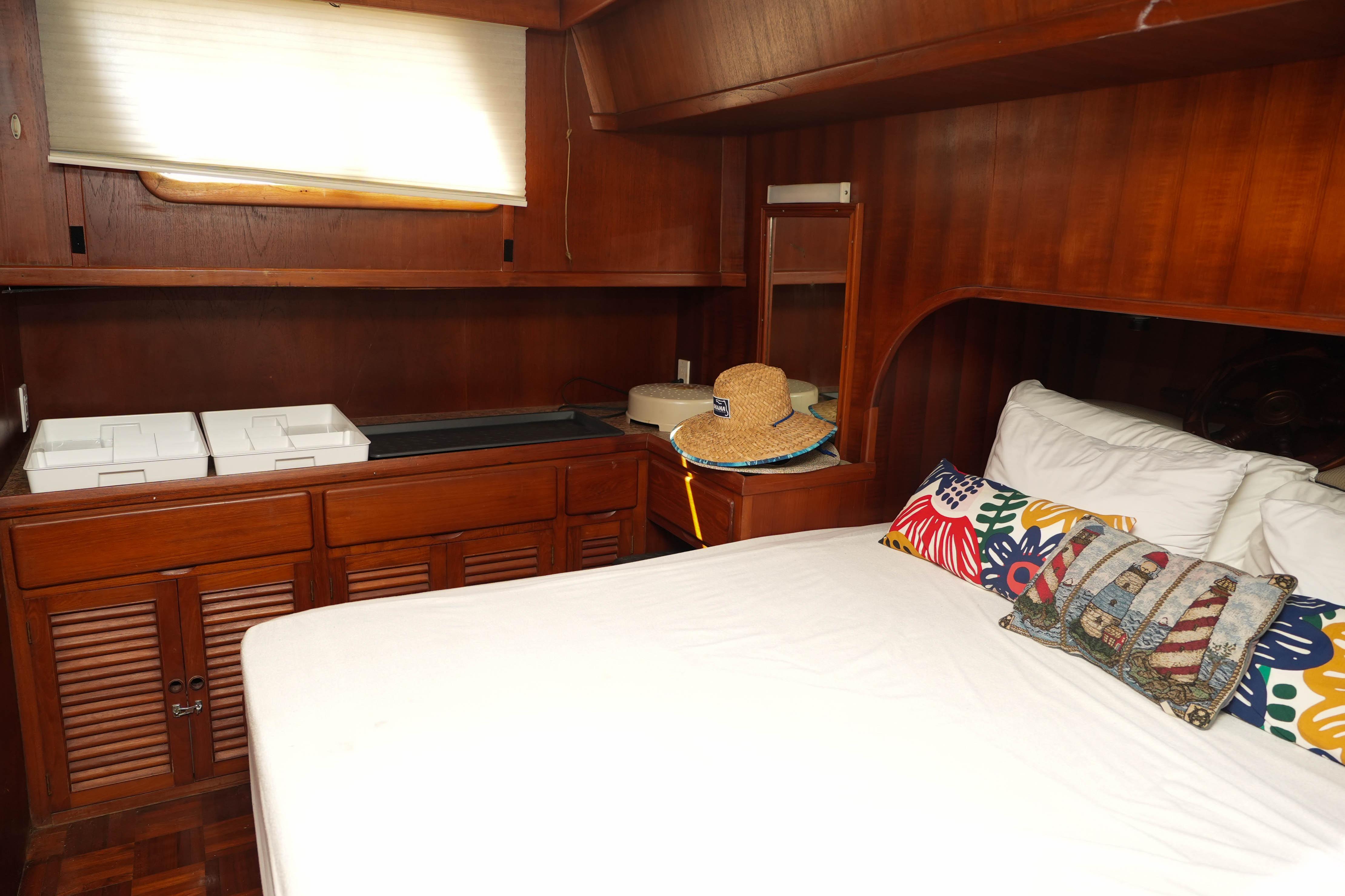 1982 CHB Classic Trawler 41 cabin with wooden interior and colorful pillows.