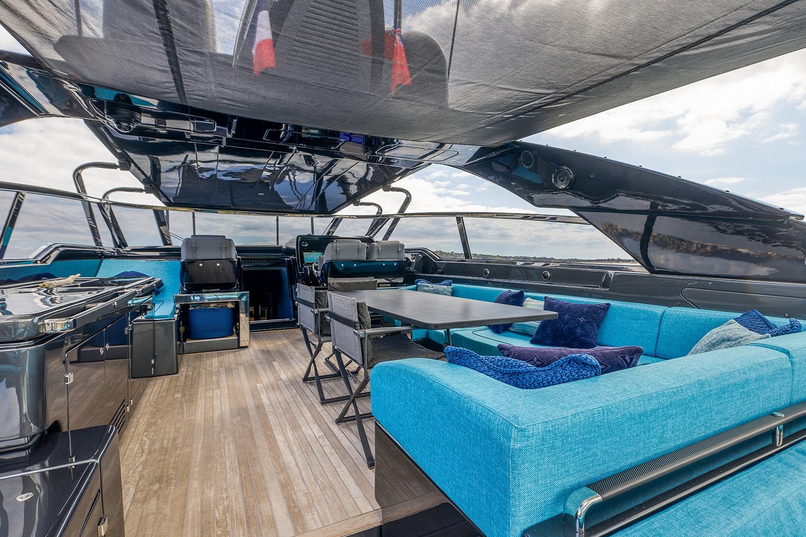 Luxurious interior of 2024 Riva 76’ Bahamas Super yacht with blue seating and modern design.