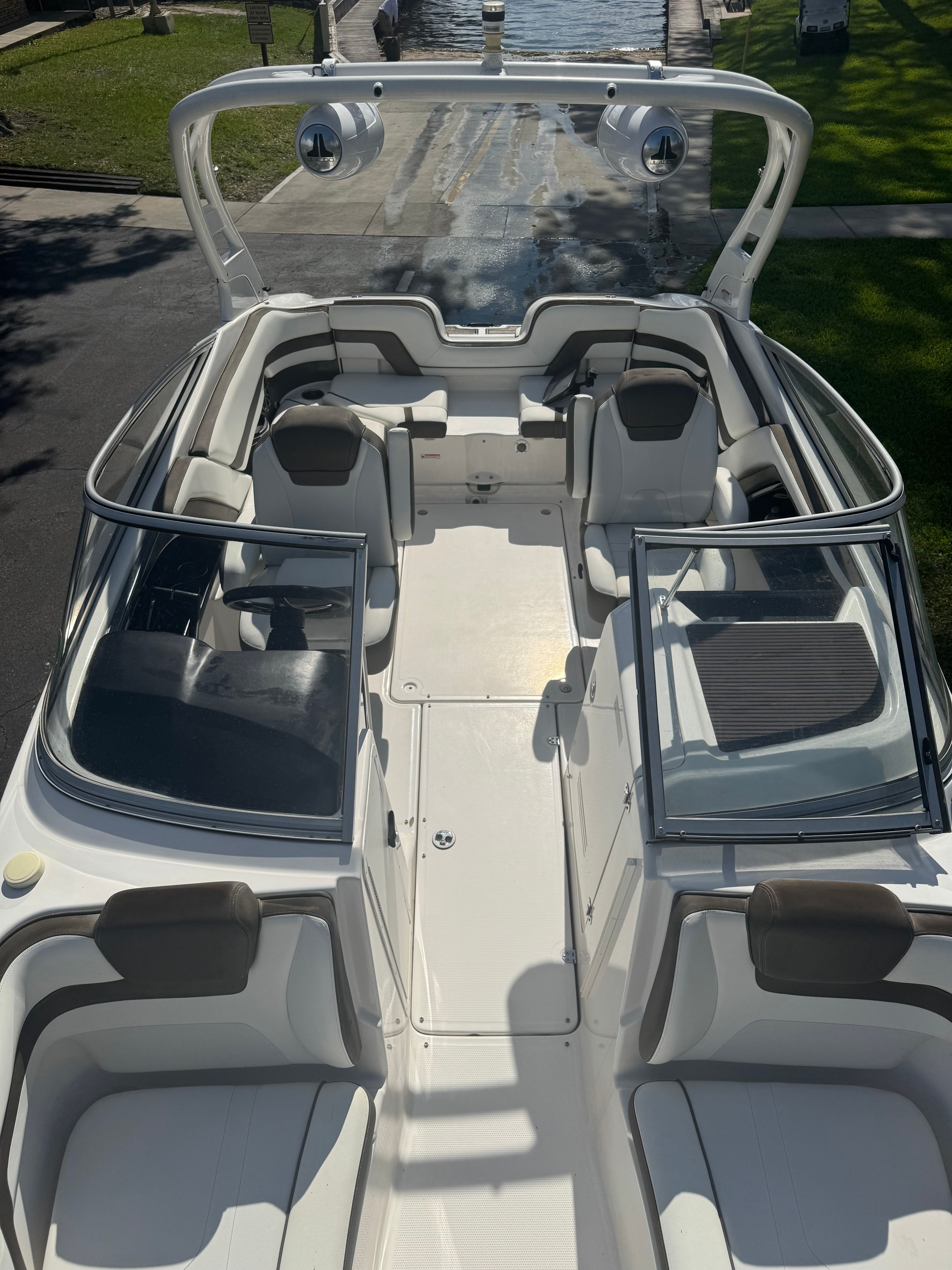 The image shows the cockpit of a 2015 Yamaha 242 Limited S boat with sleek seating.