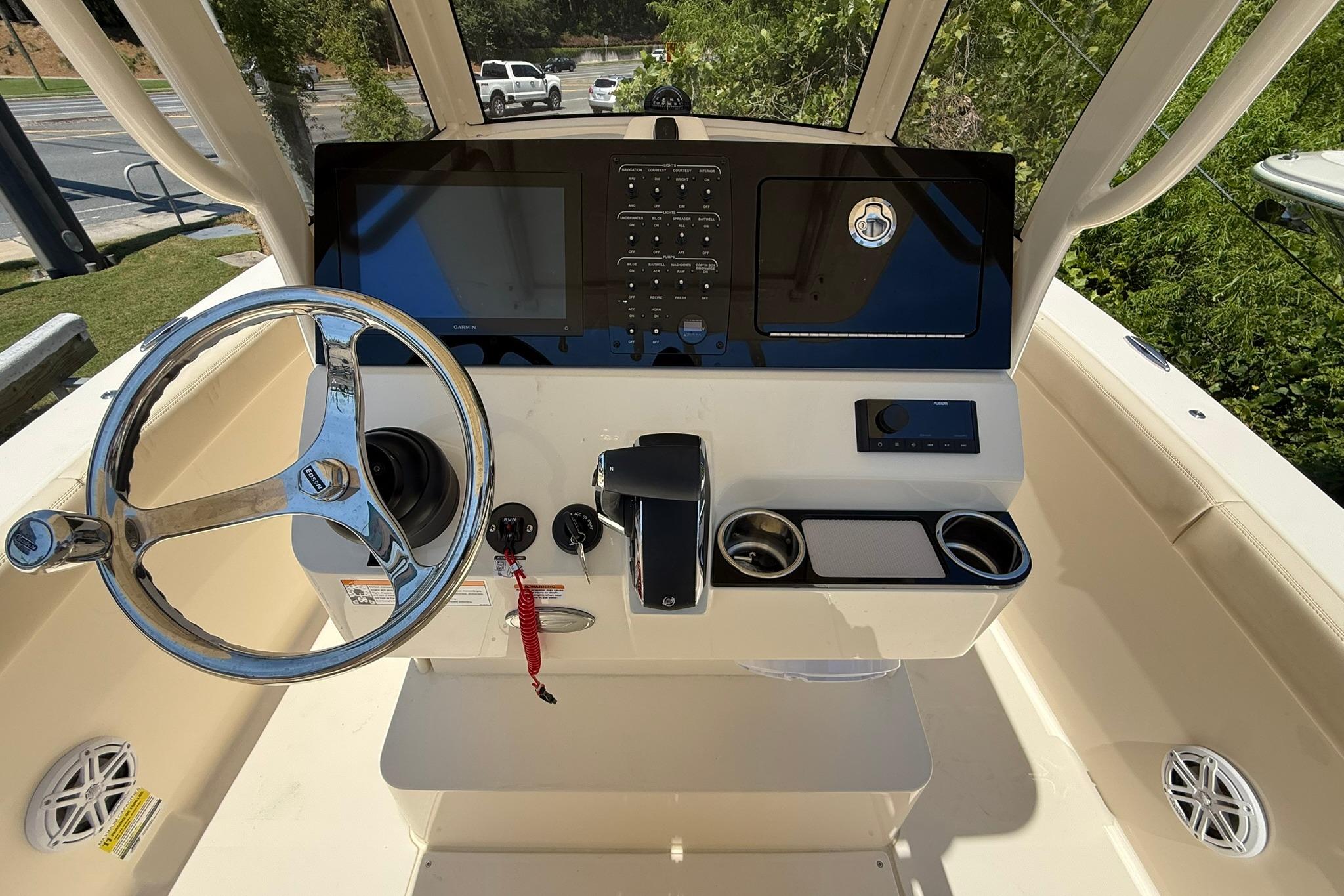 Helm of 2027 Scout 240 XSF boat with steering wheel and control panel.