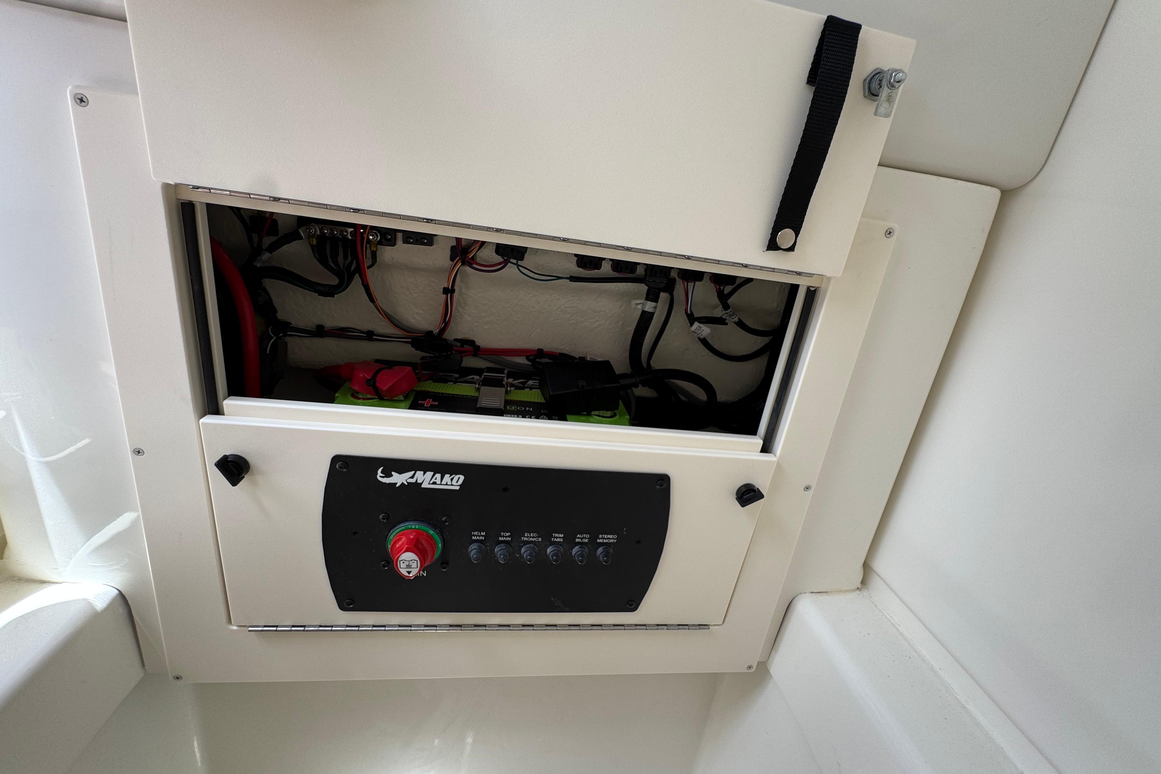 Electrical panel of 2026 Mako 214 Center Console boat, showcasing wiring and battery setup.