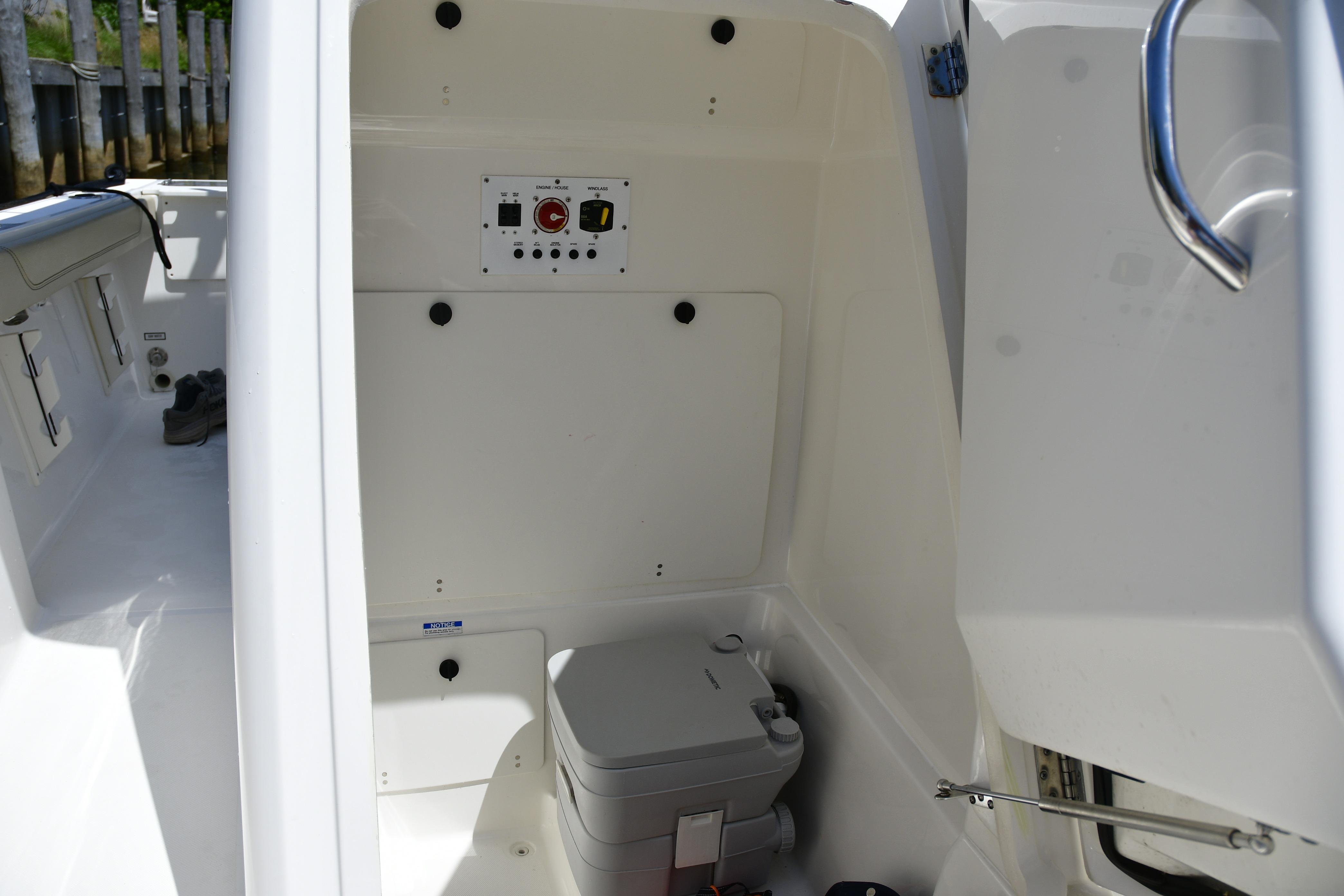 2020 Pursuit C 238 Center Console interior with control panel and portable toilet.