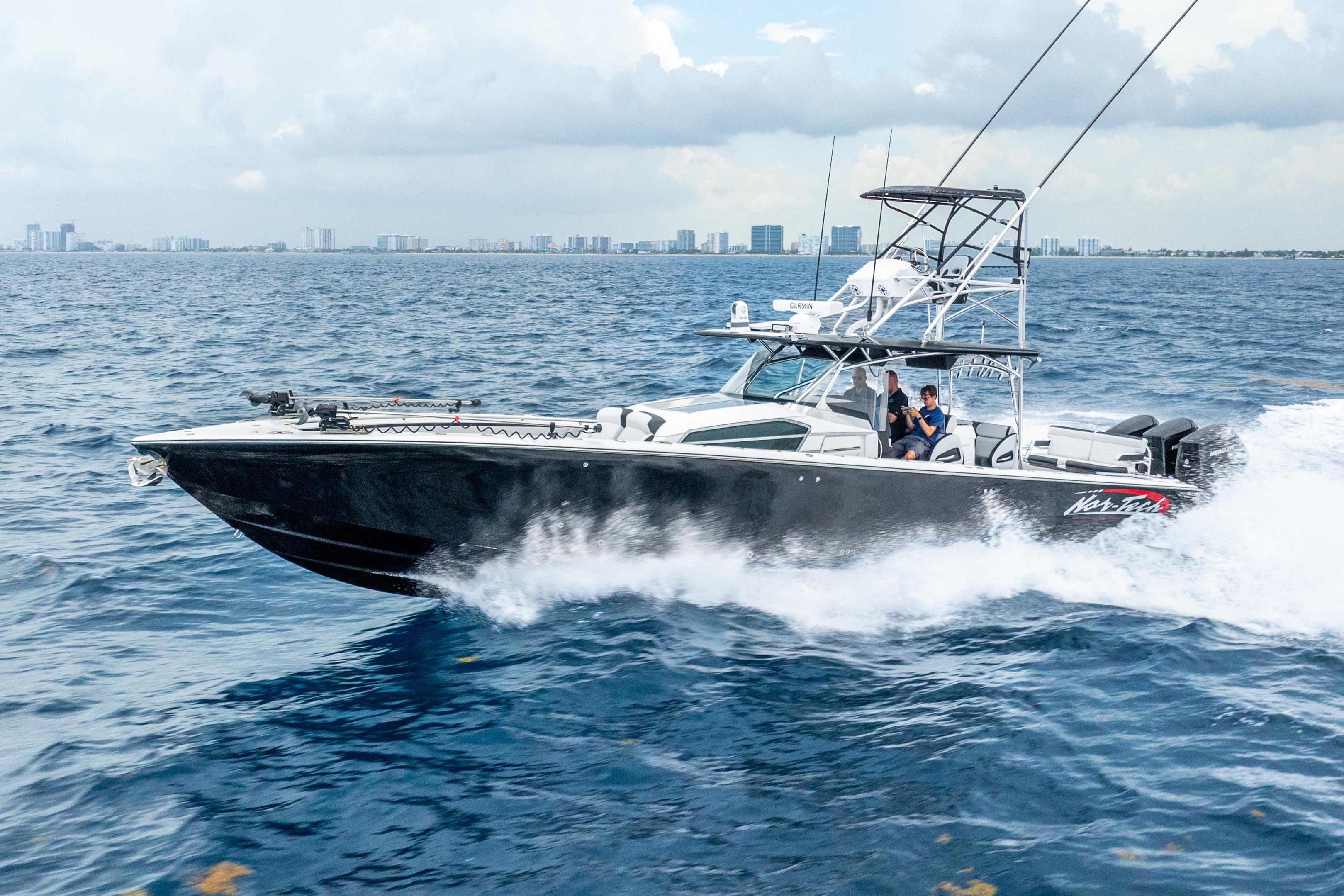 2024 Nor-Tech 452 Super Fish cruising on the ocean with city skyline in background.