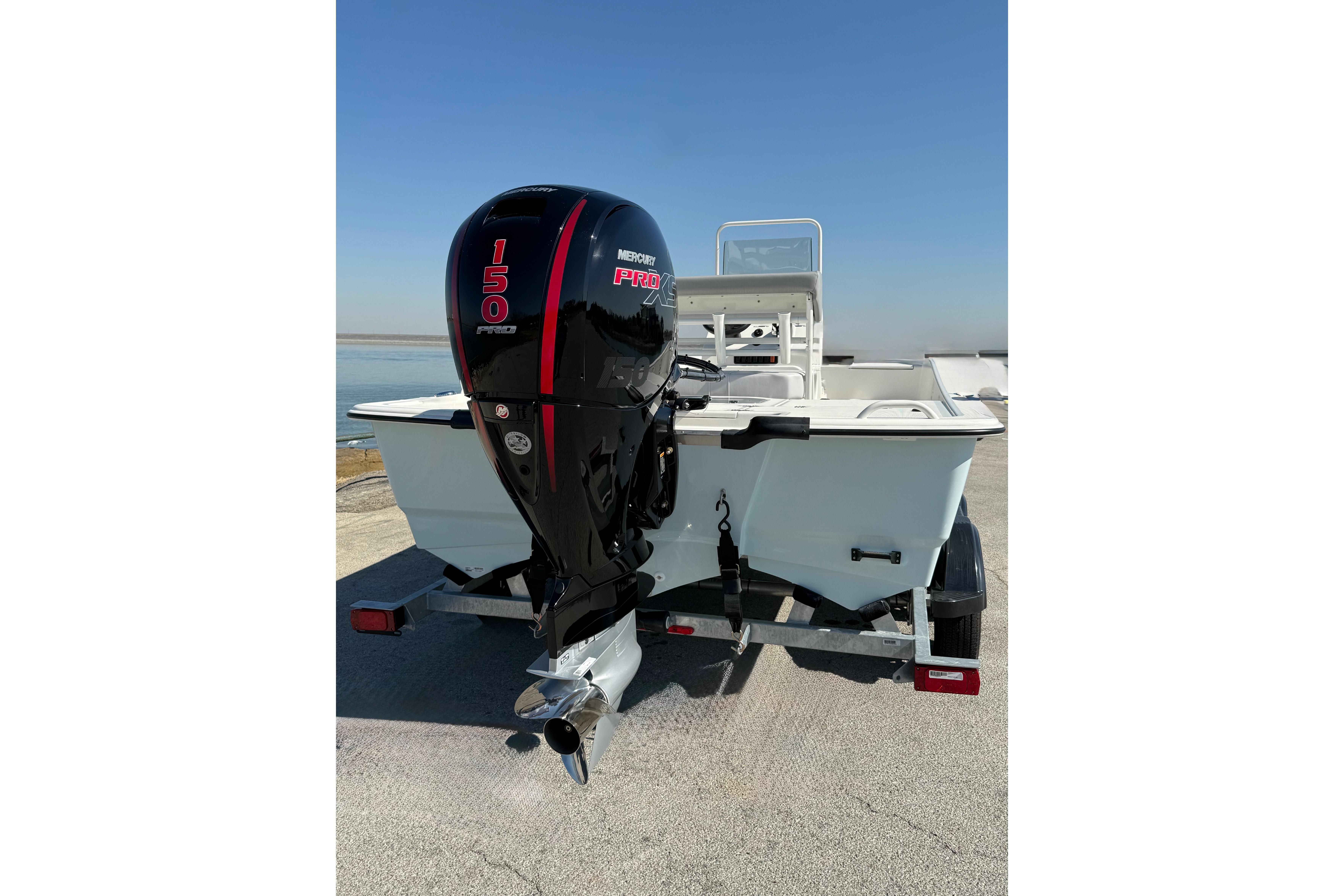 2024 Mako Pro Skiff 19 CC with Mercury 150 outboard engine on trailer.