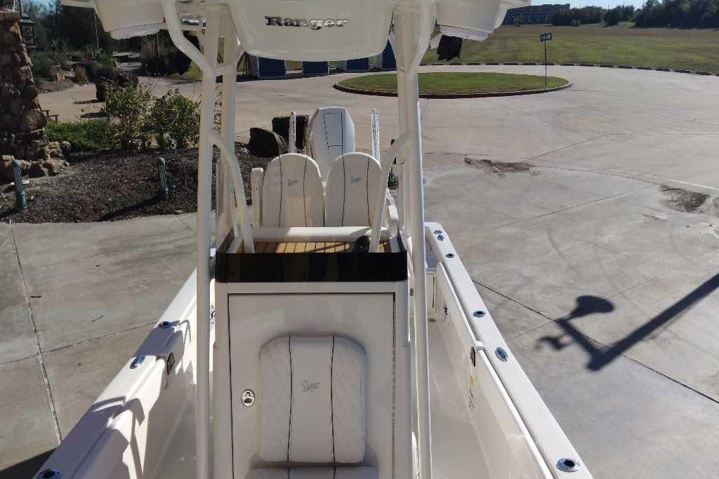 2026 Ranger 2510 Bay boat interior with seating and console, parked outdoors.