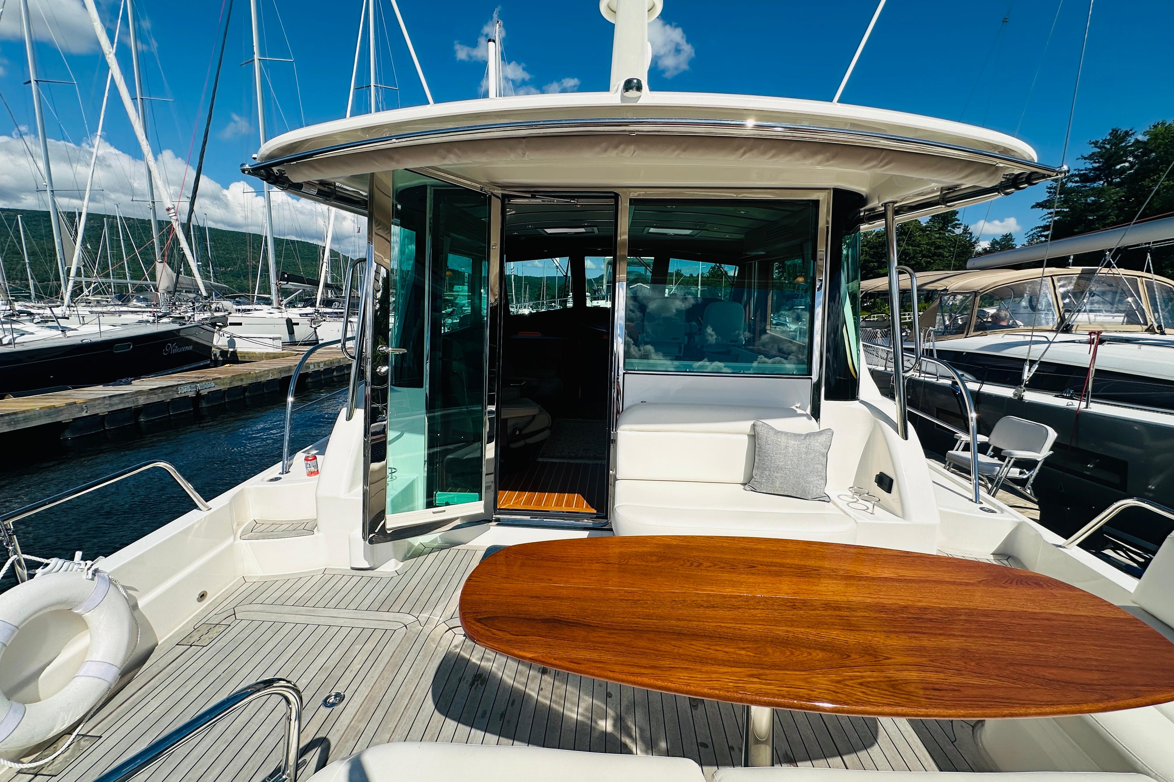 2025 Sabre 48 Salon Express yacht with elegant deck and seating area at marina.
