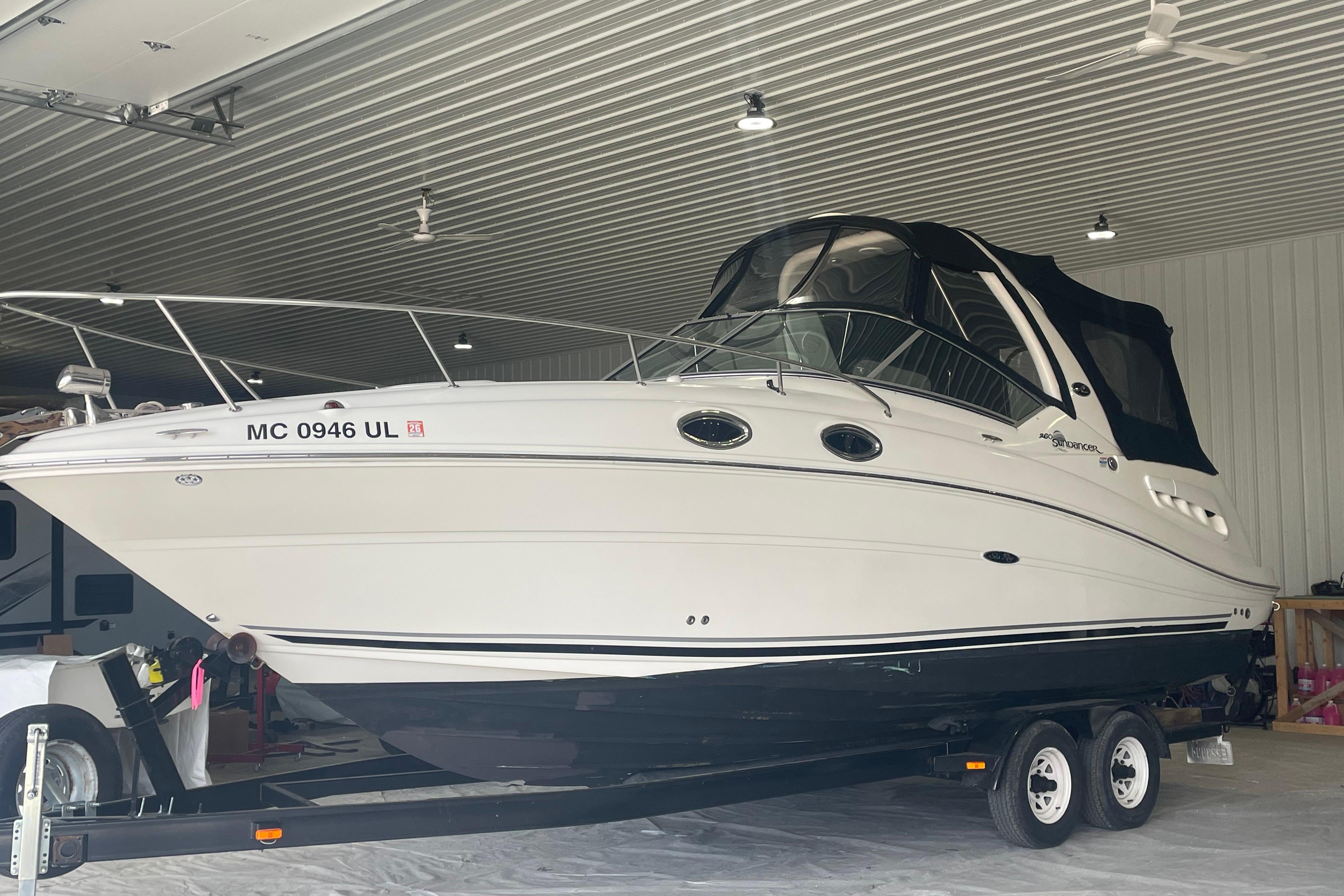 2006 Sea Ray Sundancer 260 boat on trailer in indoor storage facility.