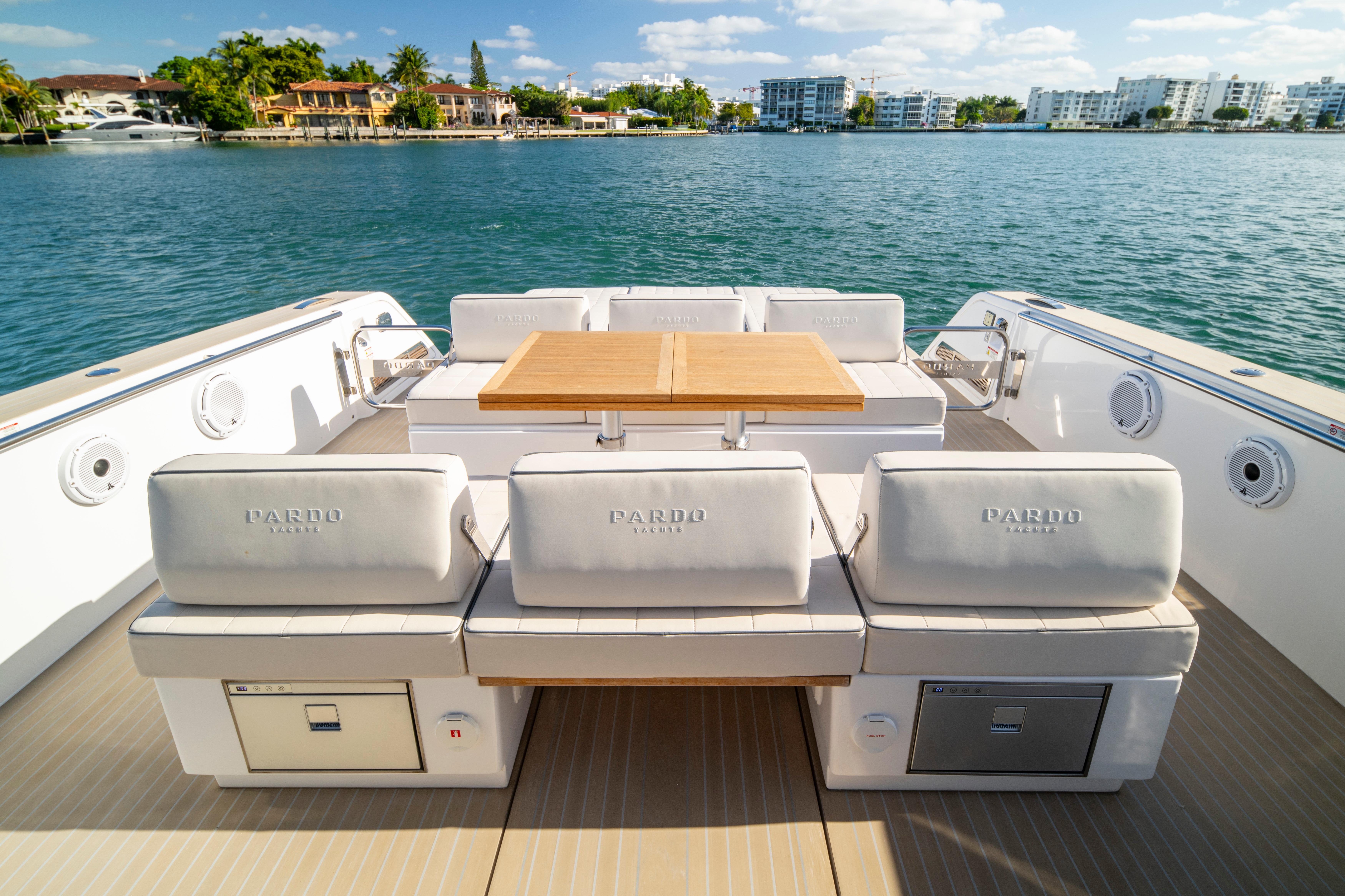 2024 Pardo Yachts P43 luxury yacht deck with seating and table, overlooking serene waters.