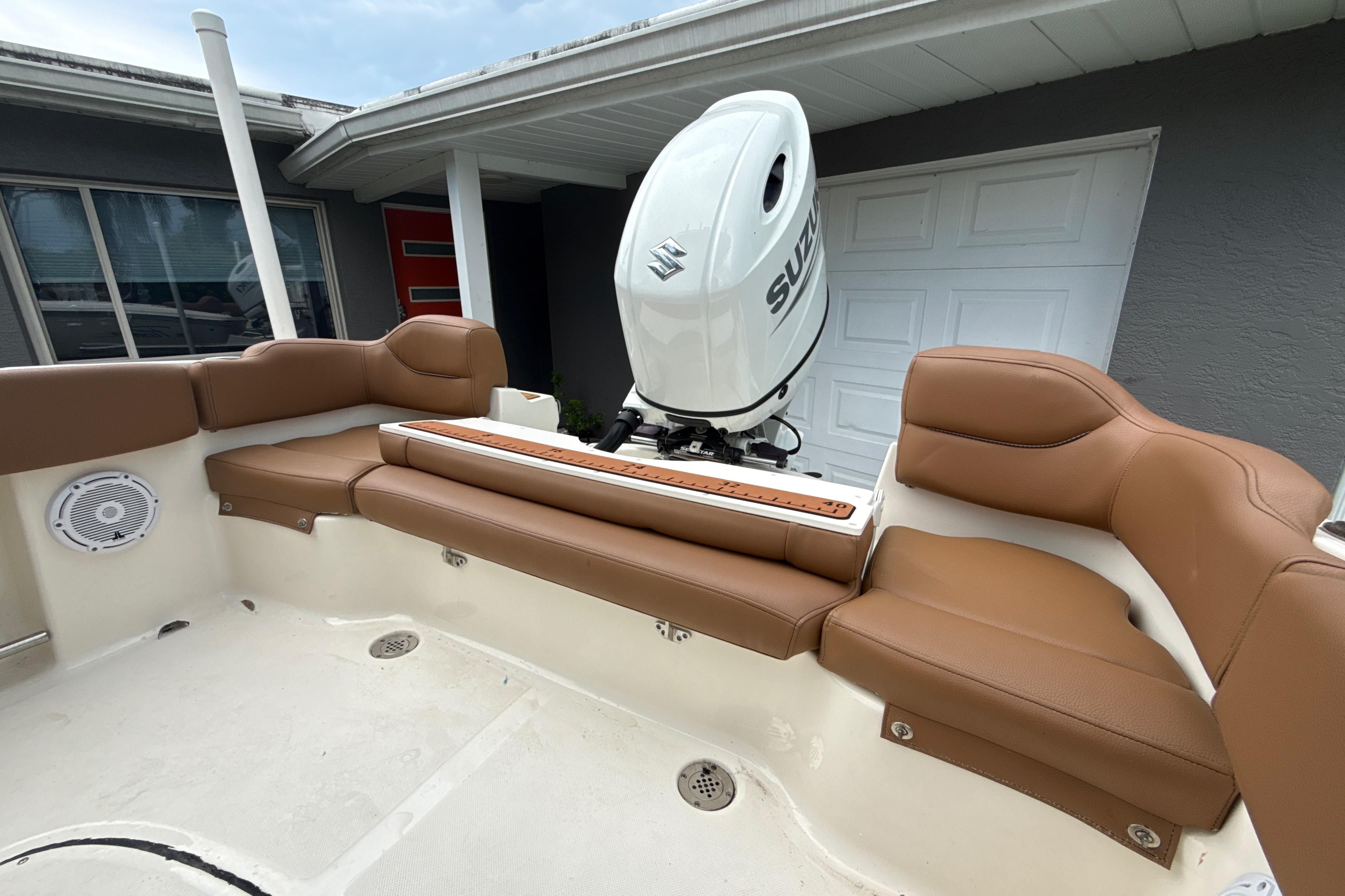 2023 Pioneer 202 Islander boat with brown seating and Suzuki outboard motor.