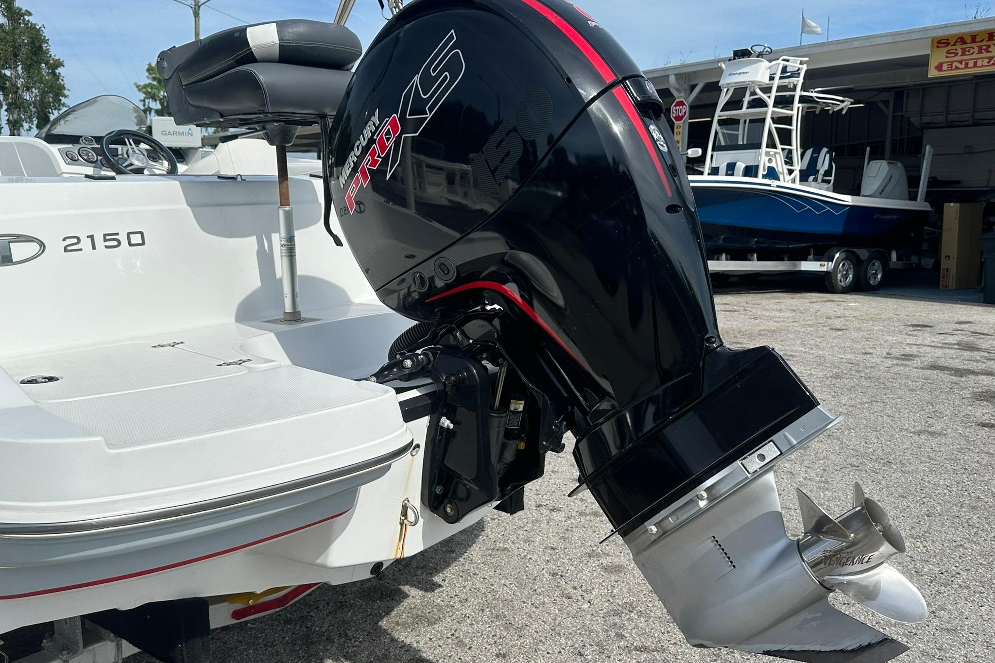 2021 Tahoe 2150 boat with Mercury Pro XS outboard motor in a marina setting.