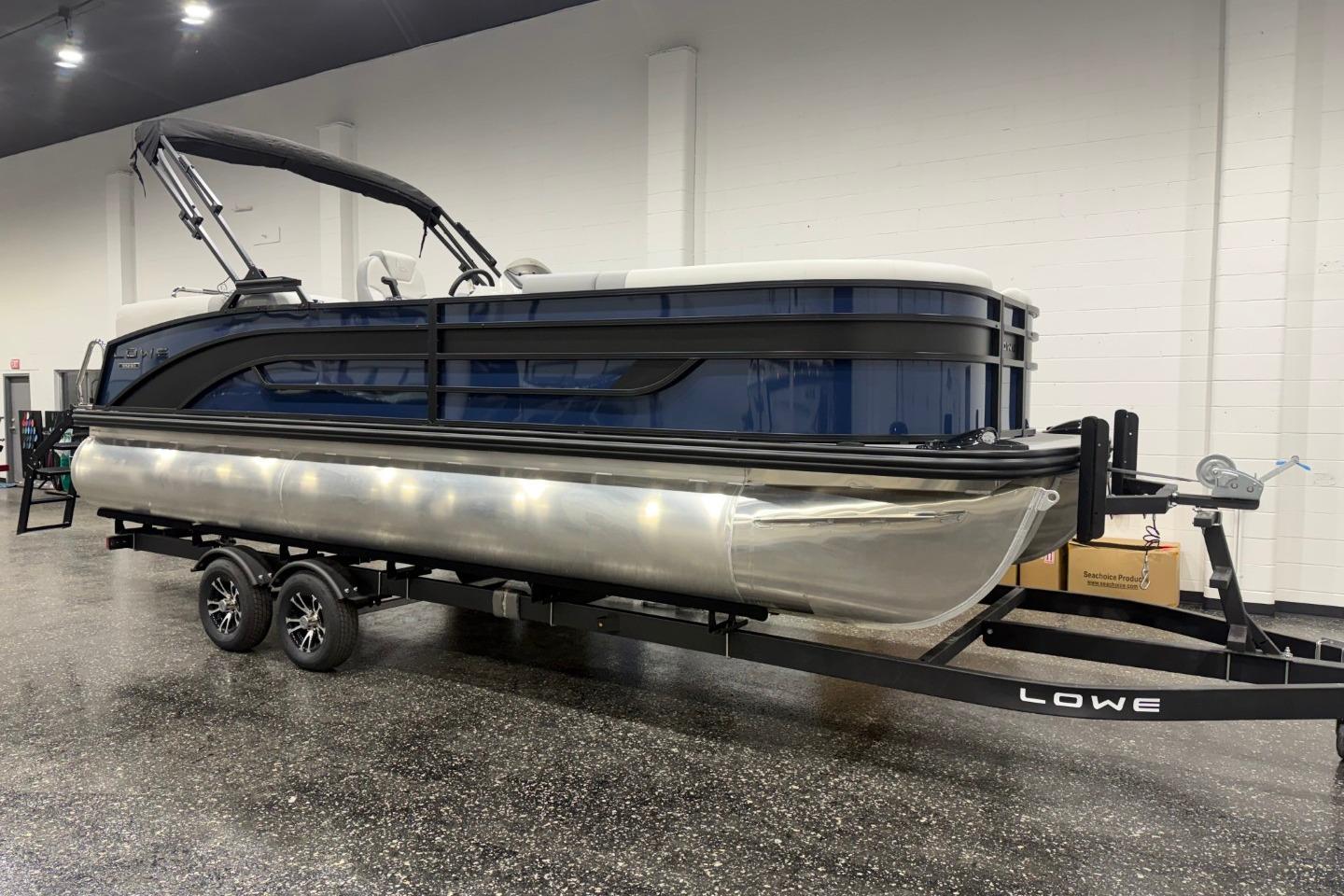 2026 Lowe SS 230 WT pontoon boat on trailer in showroom setting.