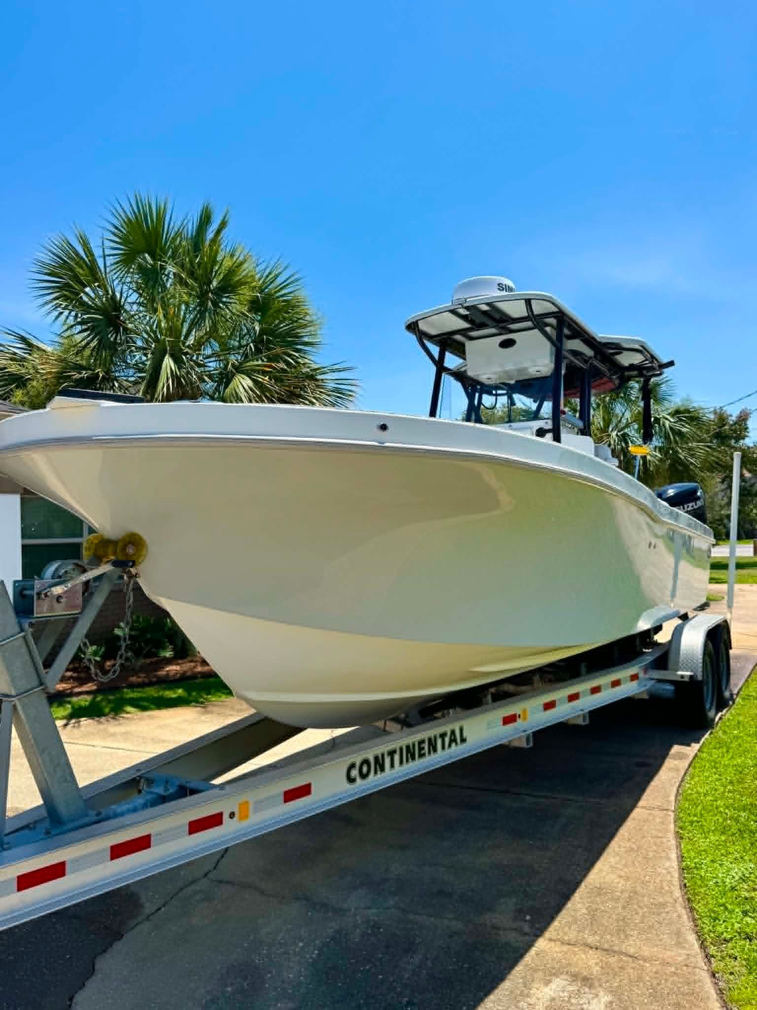 2023 Dusky 278 XFT boat on trailer, sunny day.