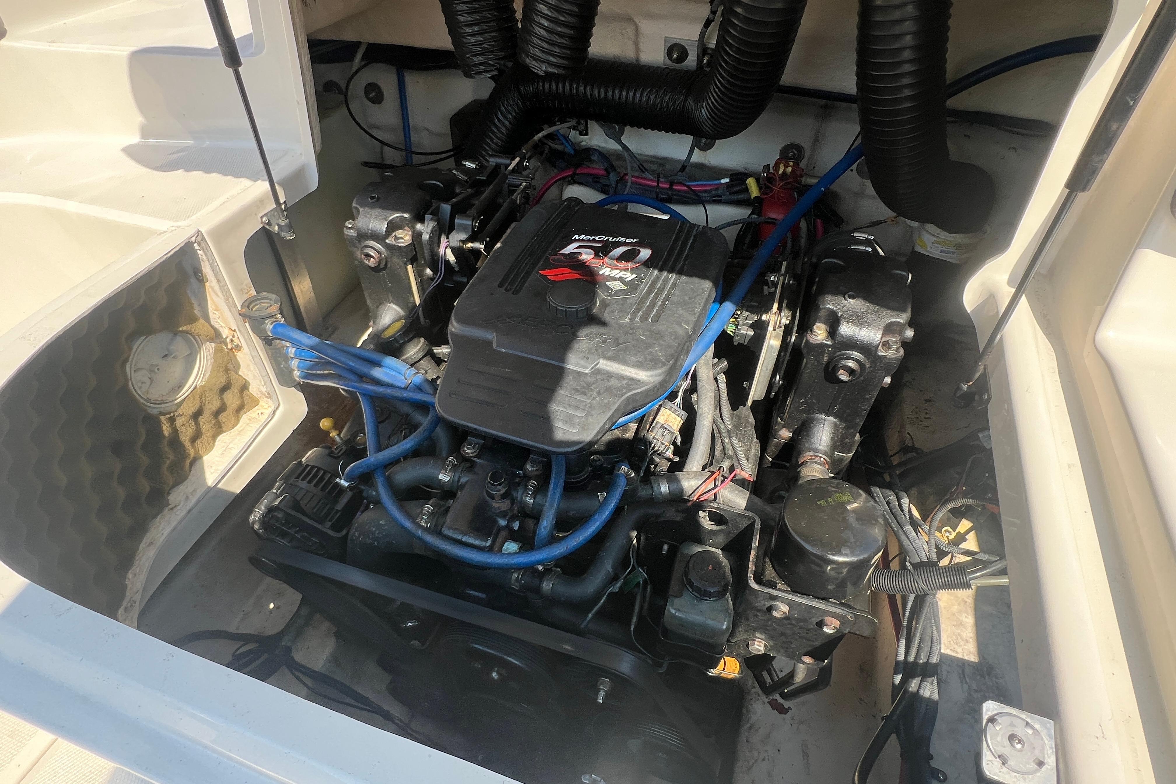 Engine compartment of a 2005 Sea Ray 240 Sundeck boat, featuring a MerCruiser engine.
