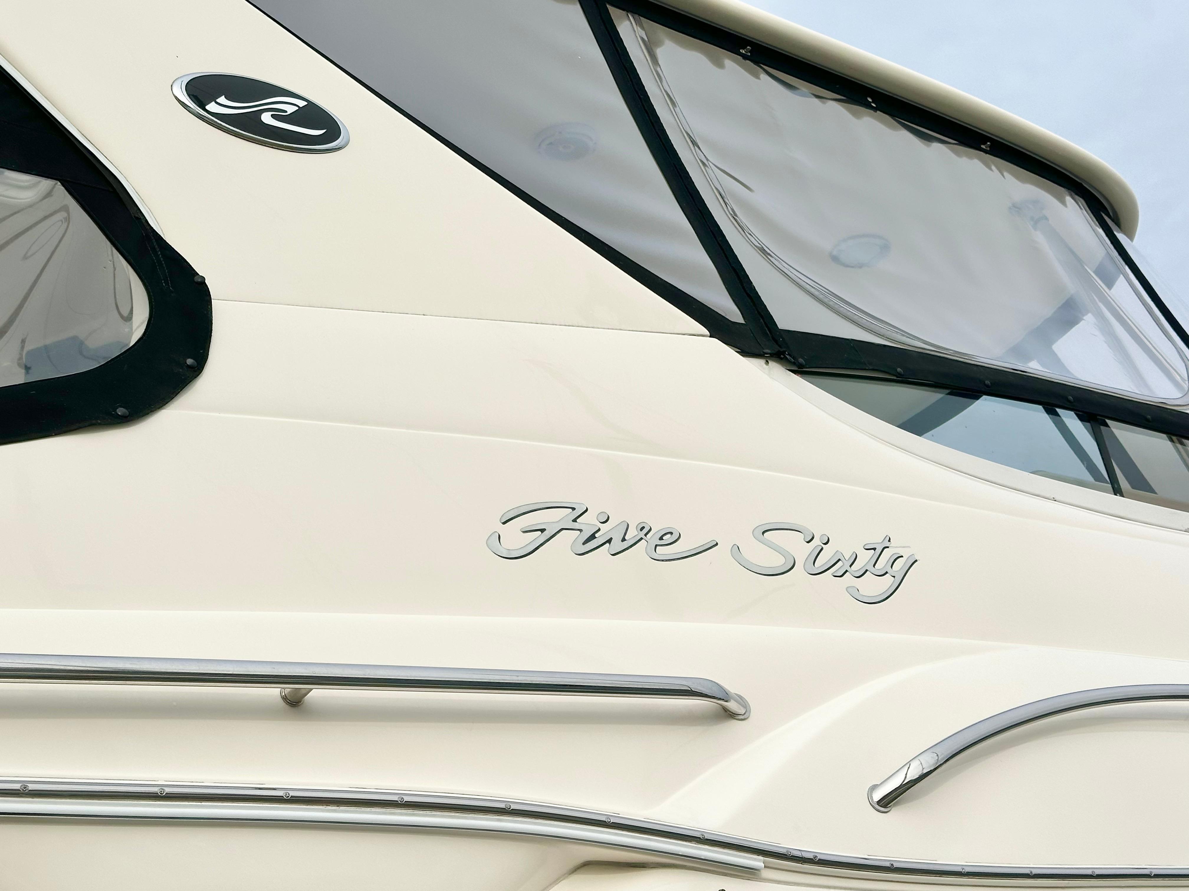 2002 Sea Ray 560 Sedan Bridge yacht, side view with "Five Sixty" lettering.