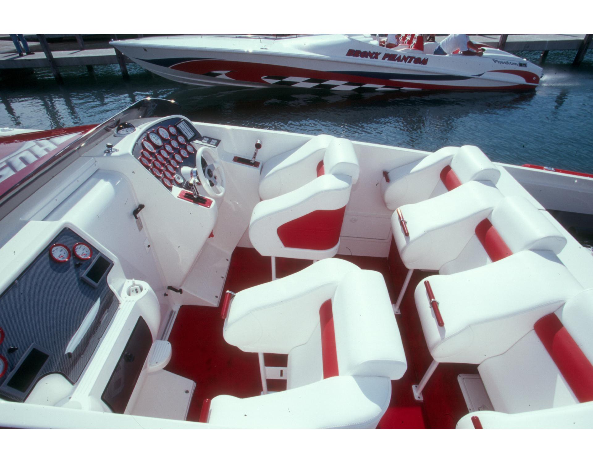 2004 Hustler 388 SLINGSHOT boat interior with red and white seating and dashboard.