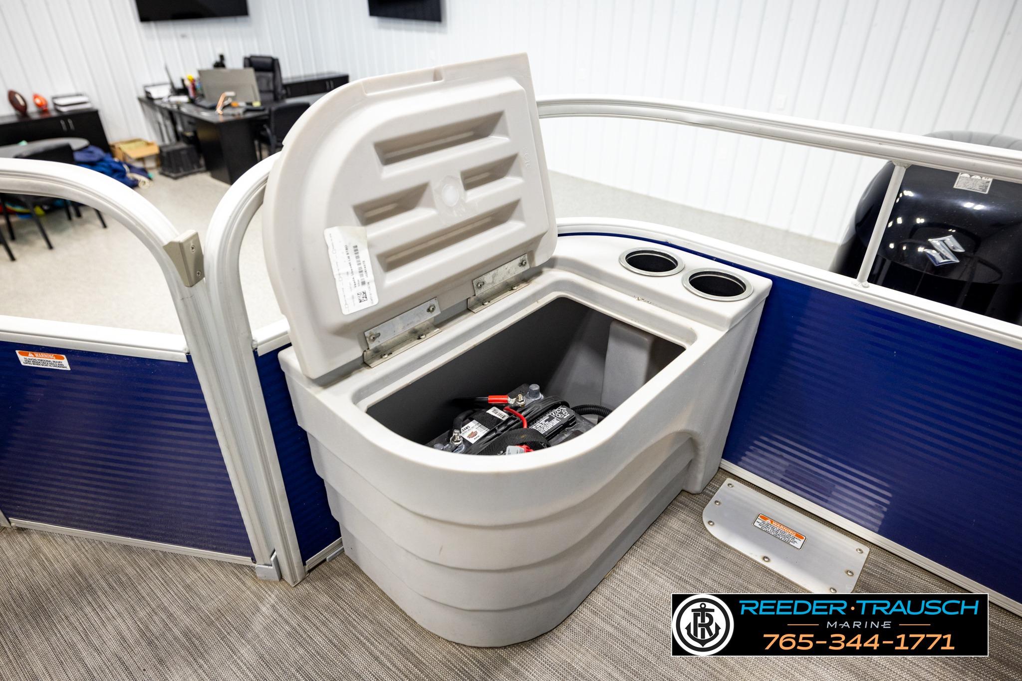 2021 Bennington 20 SV pontoon boat battery compartment with open lid and cup holders.