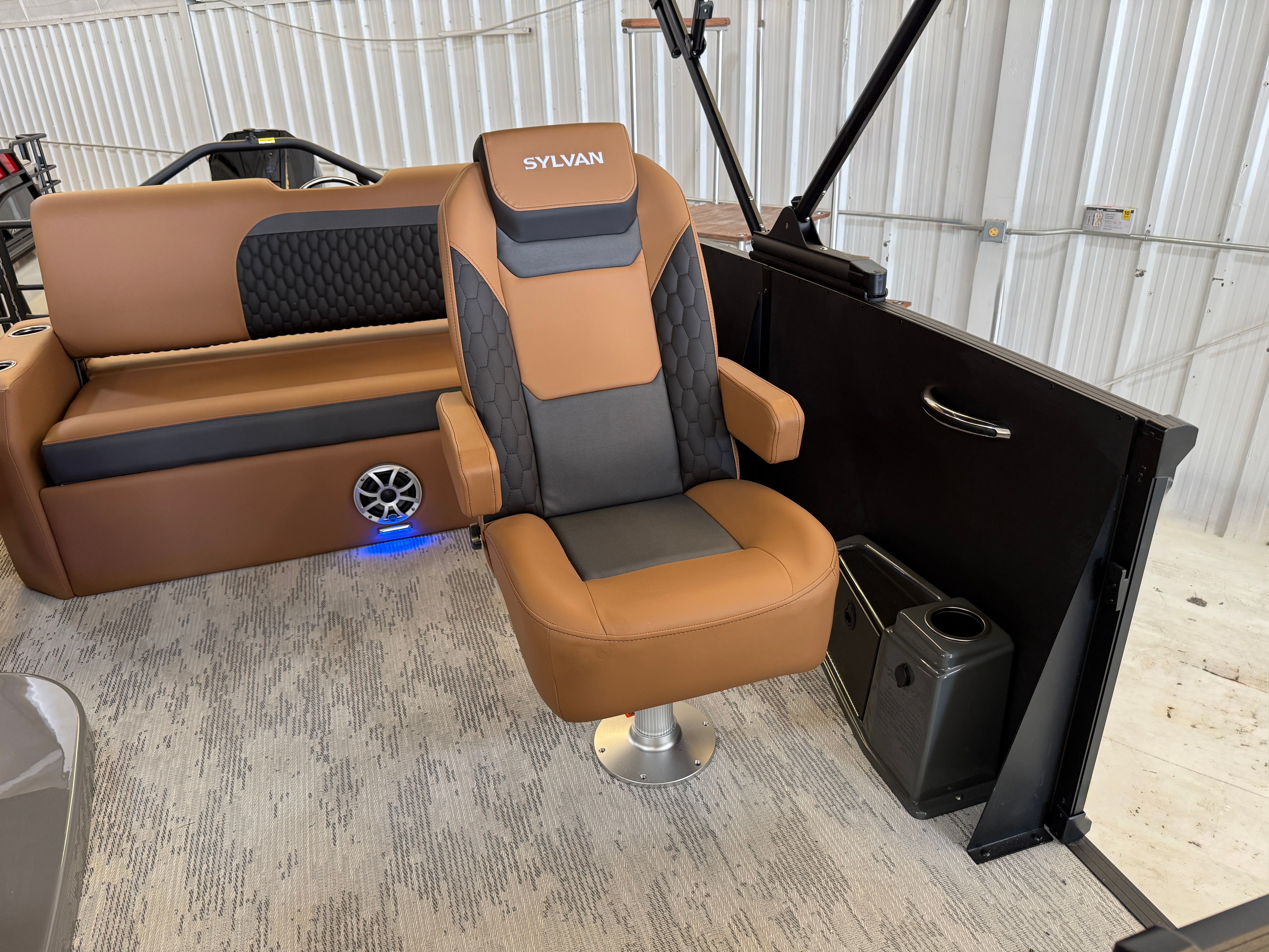 Interior of a 2026 Sylvan L3 ULZ DH with brown seating and speaker.