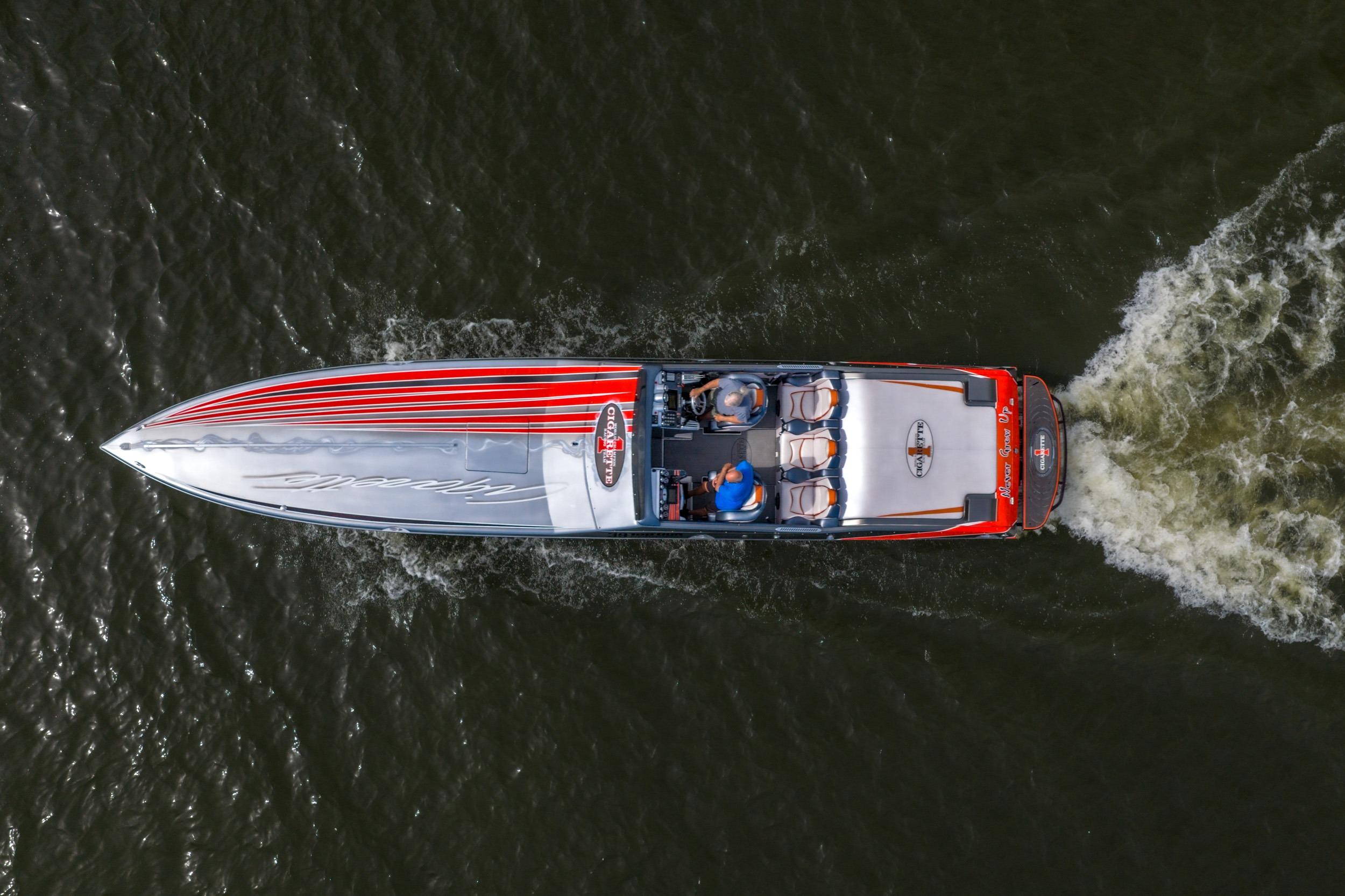 2006 Cigarette 39' Top Gun speedboat cruising on water, aerial view.