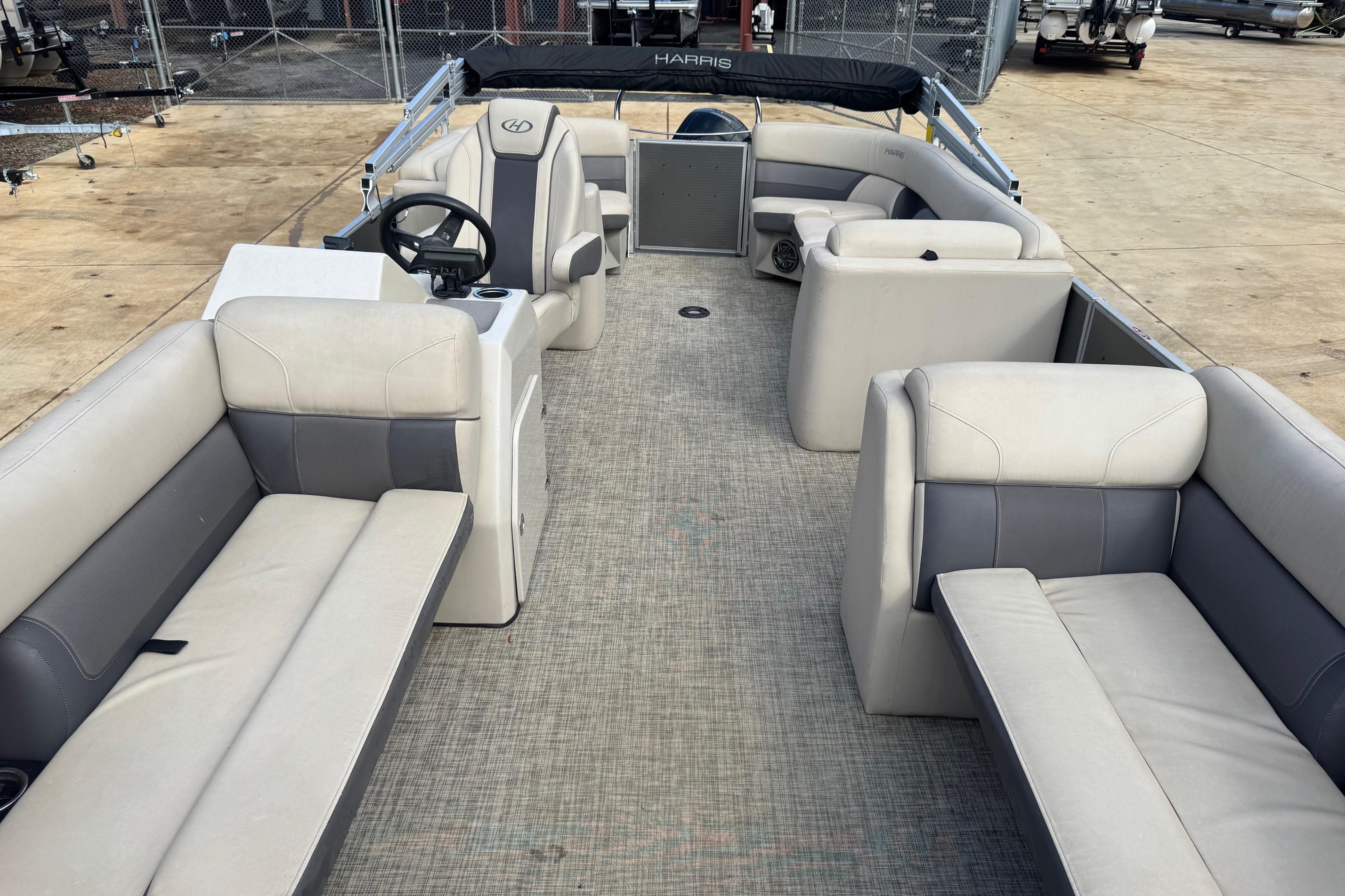 2023 Harris Cruiser 230 pontoon boat interior with spacious seating and steering console.