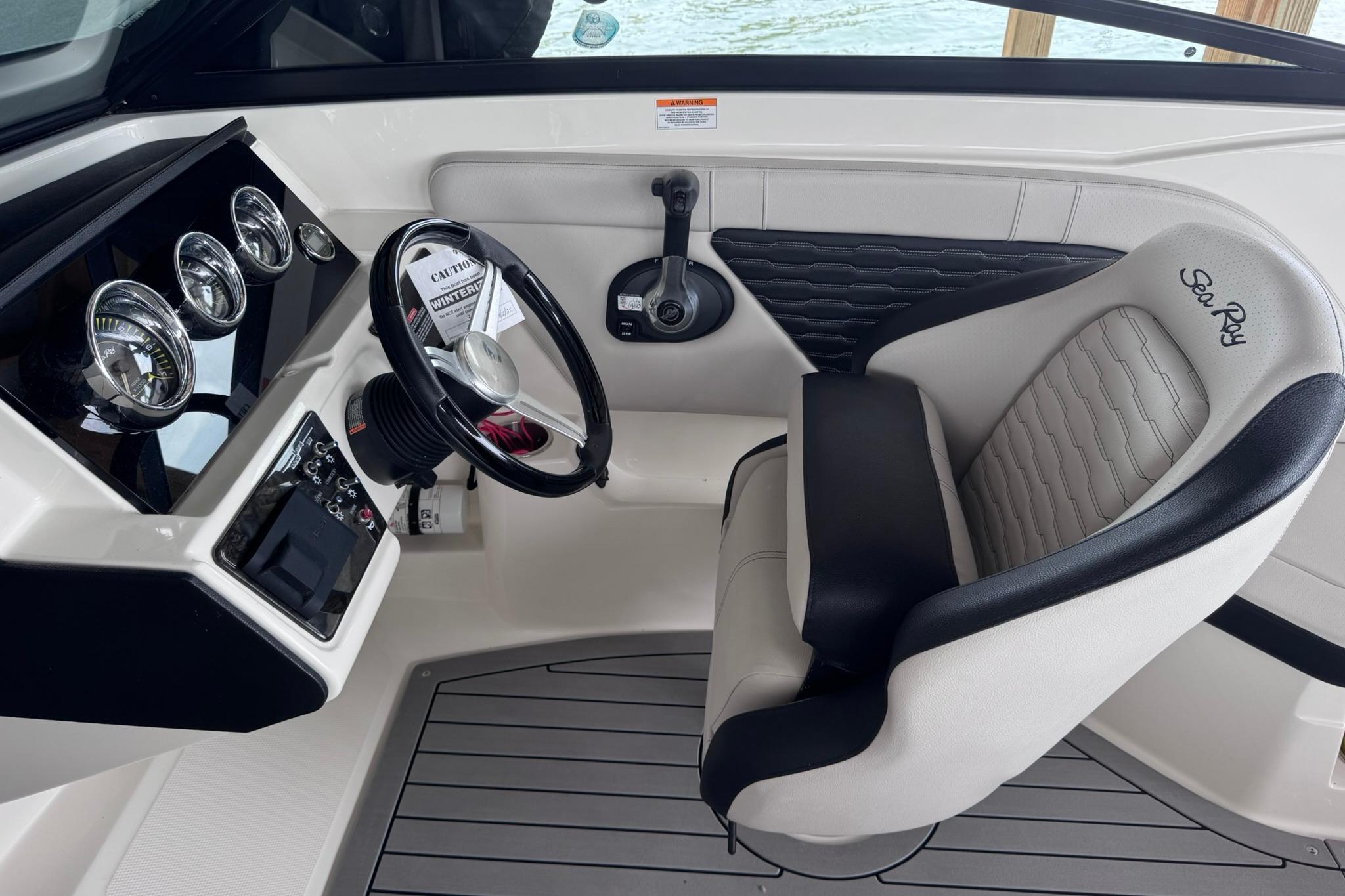 2021 Sea Ray SPX 230 boat cockpit with steering wheel and gauges.