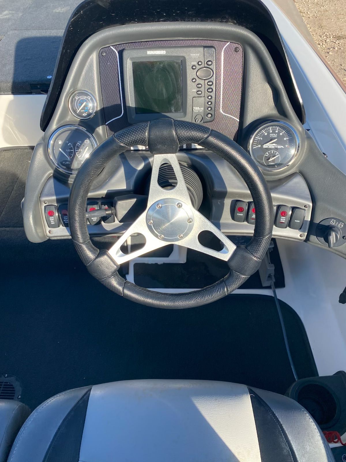 Steering wheel and dashboard of a 2012 Skeeter ZX20 boat.