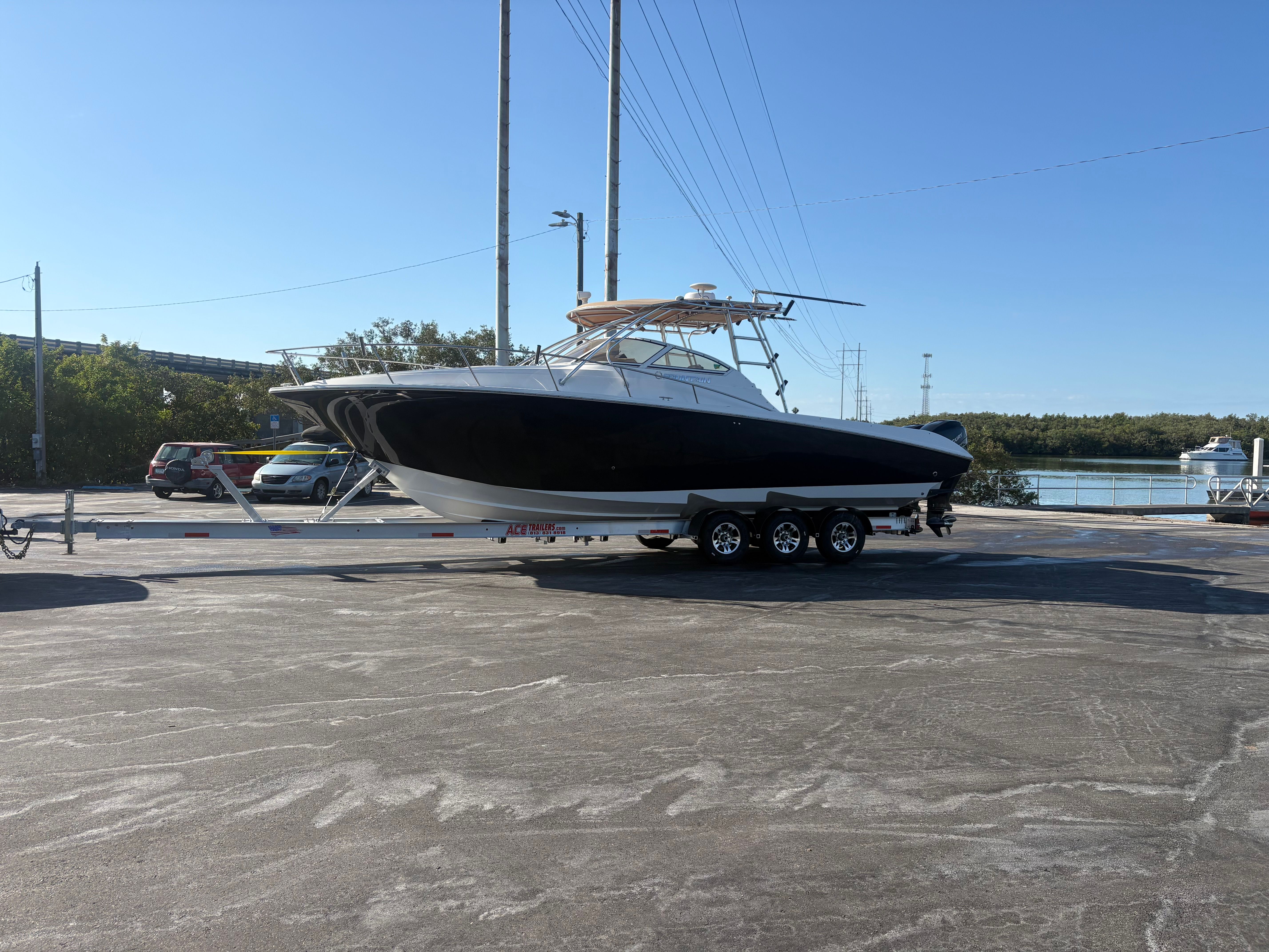 2009 Fountain 33 Sportfish Cruiser on trailer by the water.