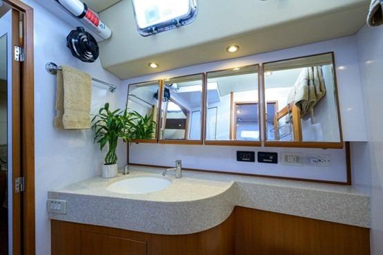 Luxurious bathroom interior of 2009 Hylas 70 yacht with modern fixtures and elegant design.
