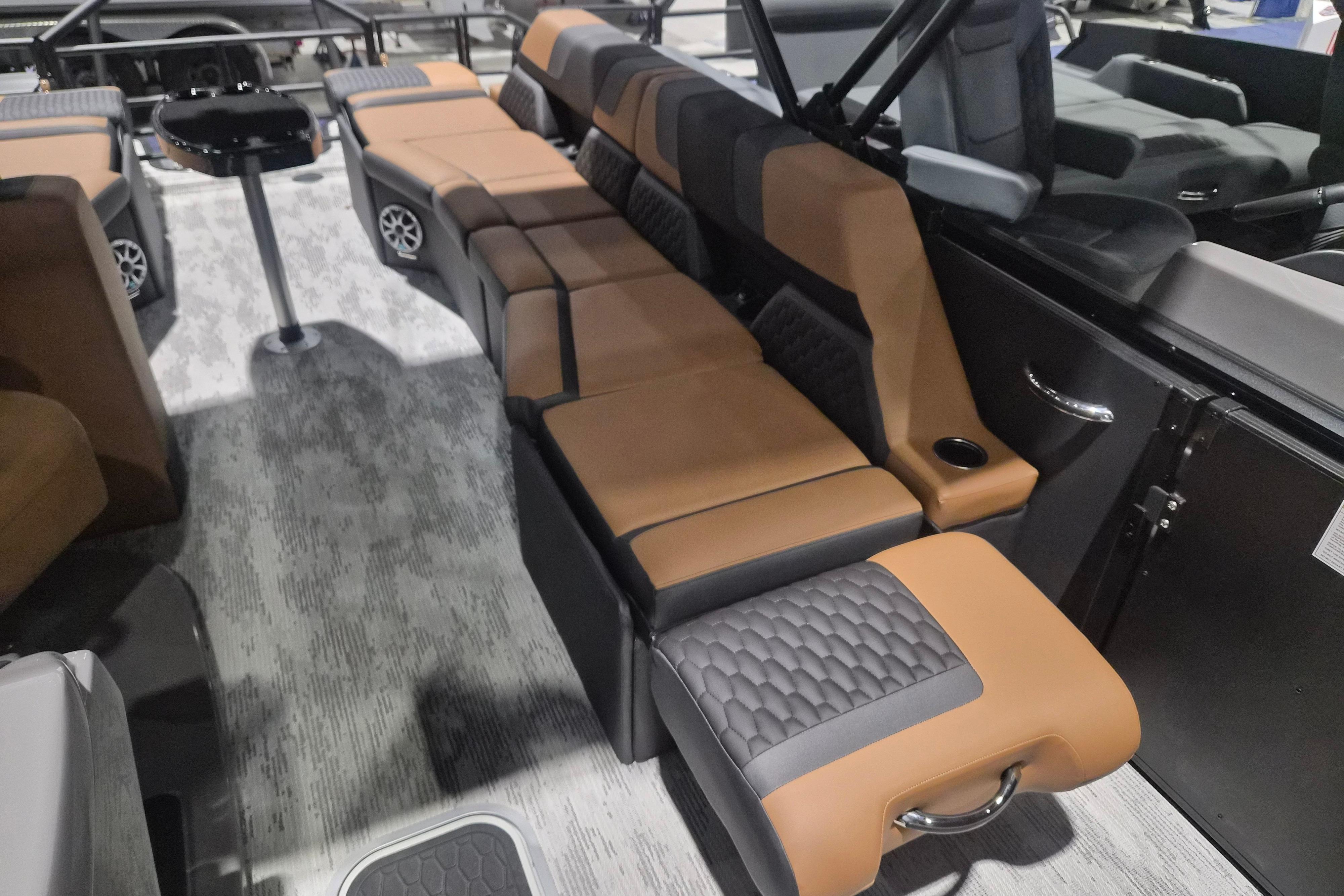 2026 Sylvan L3 SLZ boat interior with luxurious brown and black seating arrangement.