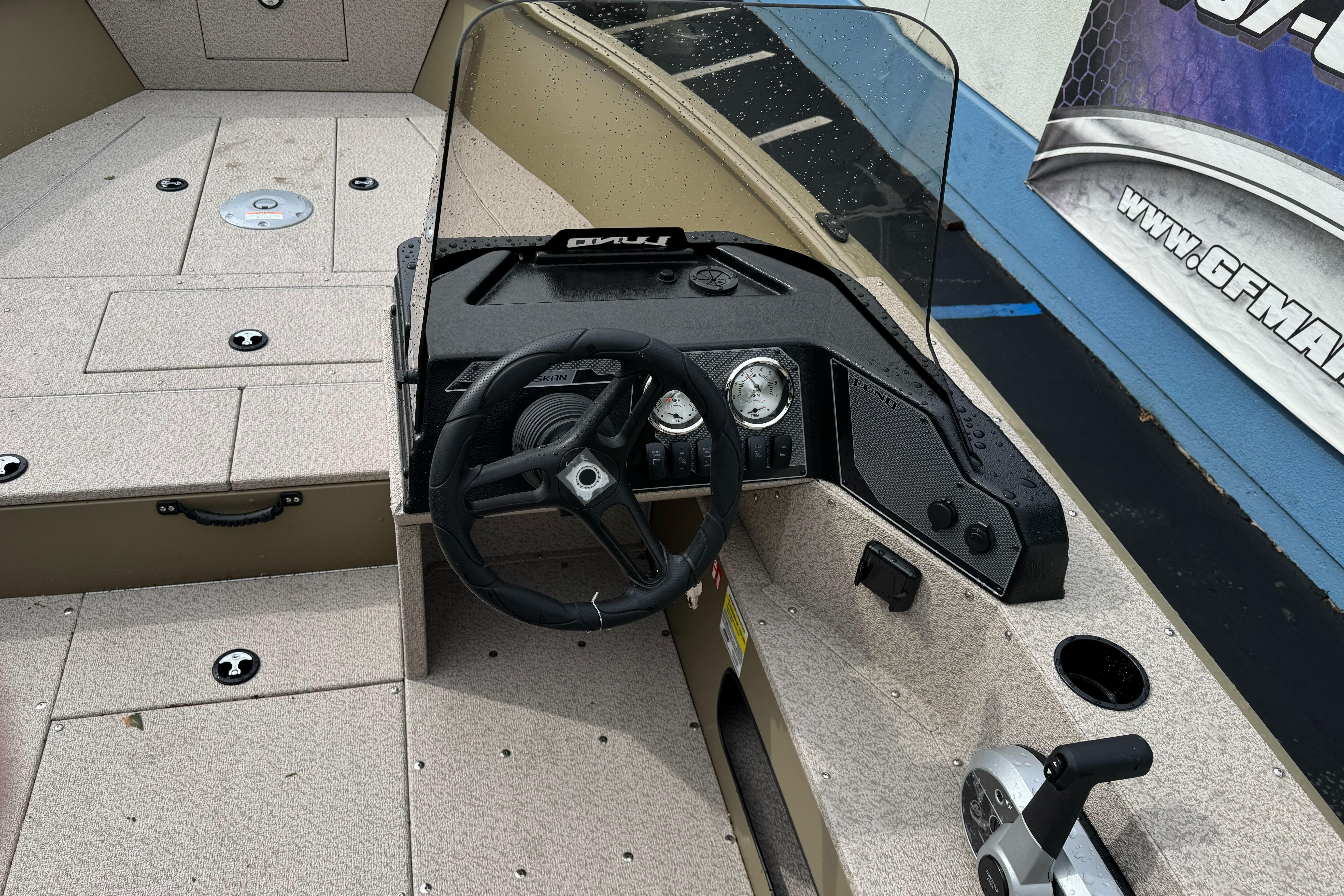 2026 Lund 2075 Alaskan SS boat dashboard with steering wheel and controls.