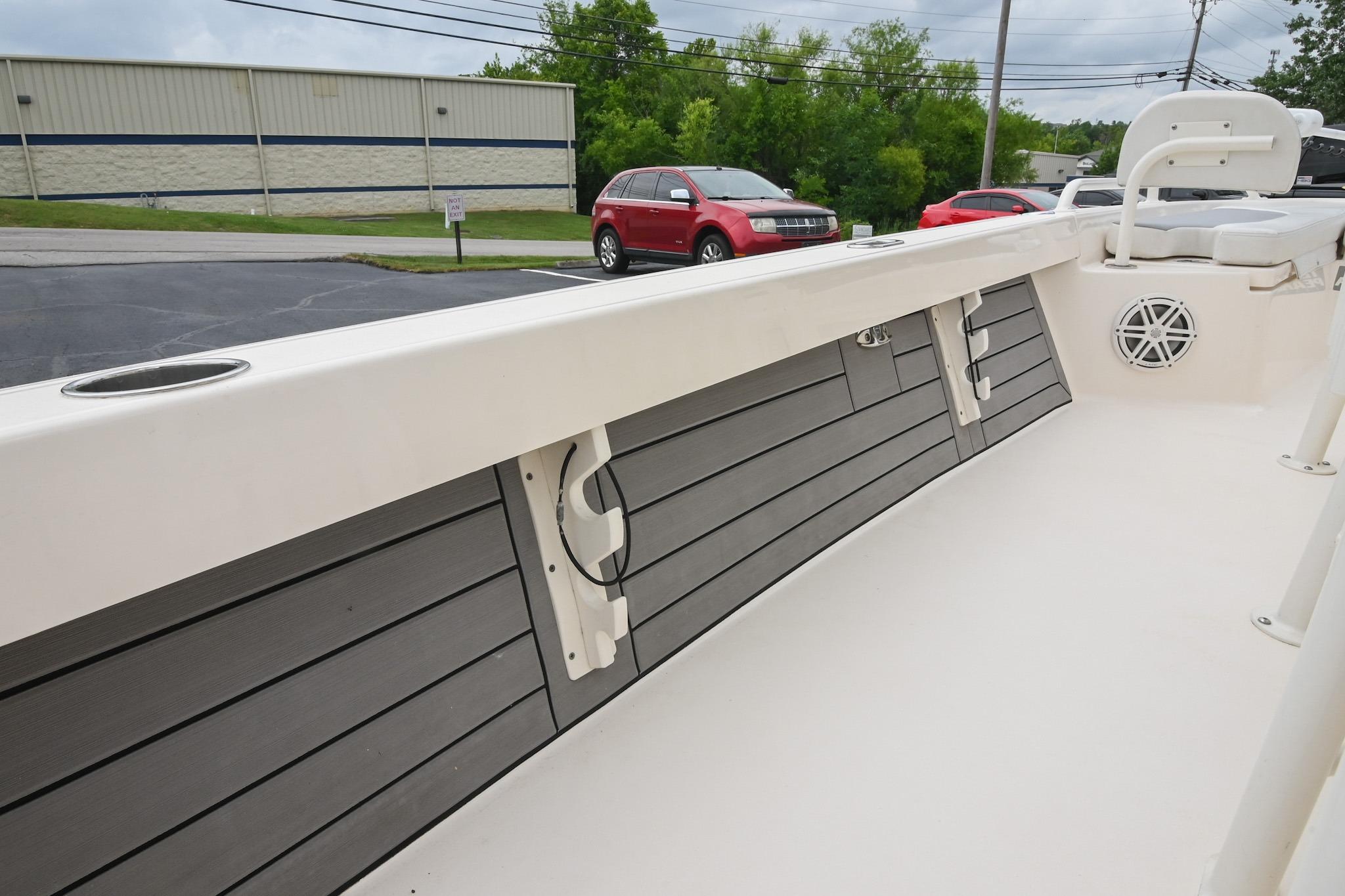 2021 Pathfinder 2200 TRS boat interior with rod holders and speaker, parked outdoors.