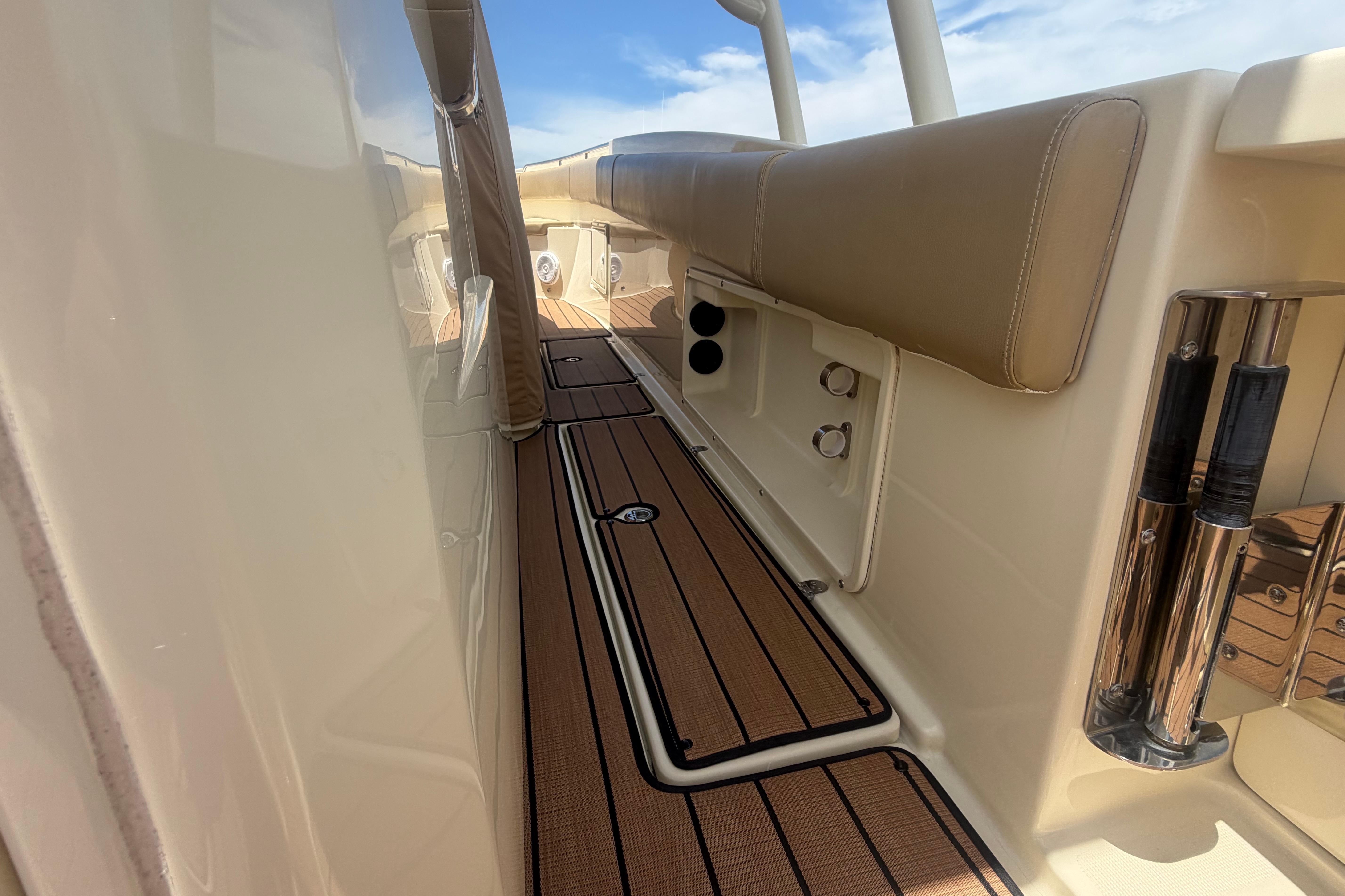 2017 Chris-Craft Catalina 34 boat deck with teak flooring and beige seating.