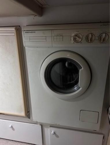 1986 Egg Harbor 60 Sportfisherman interior with built-in washing machine.