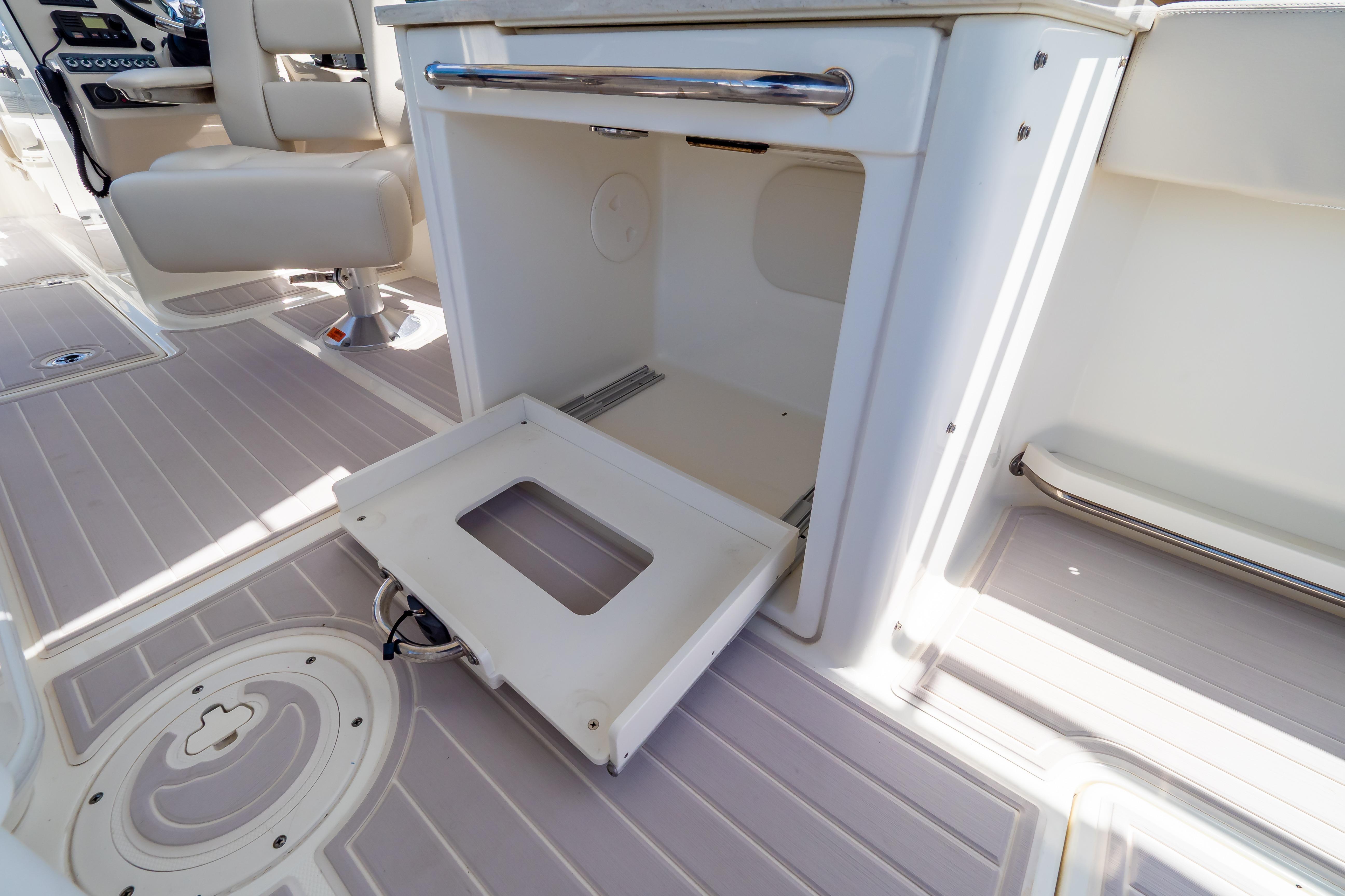 2019 Boston Whaler 270 Vantage interior with open storage compartment and seating.