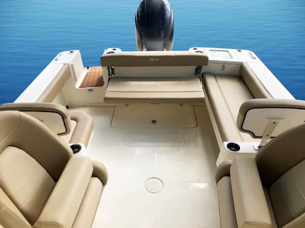 2025 Scout 215 Dorado boat interior with beige seating and sleek design on calm water.
