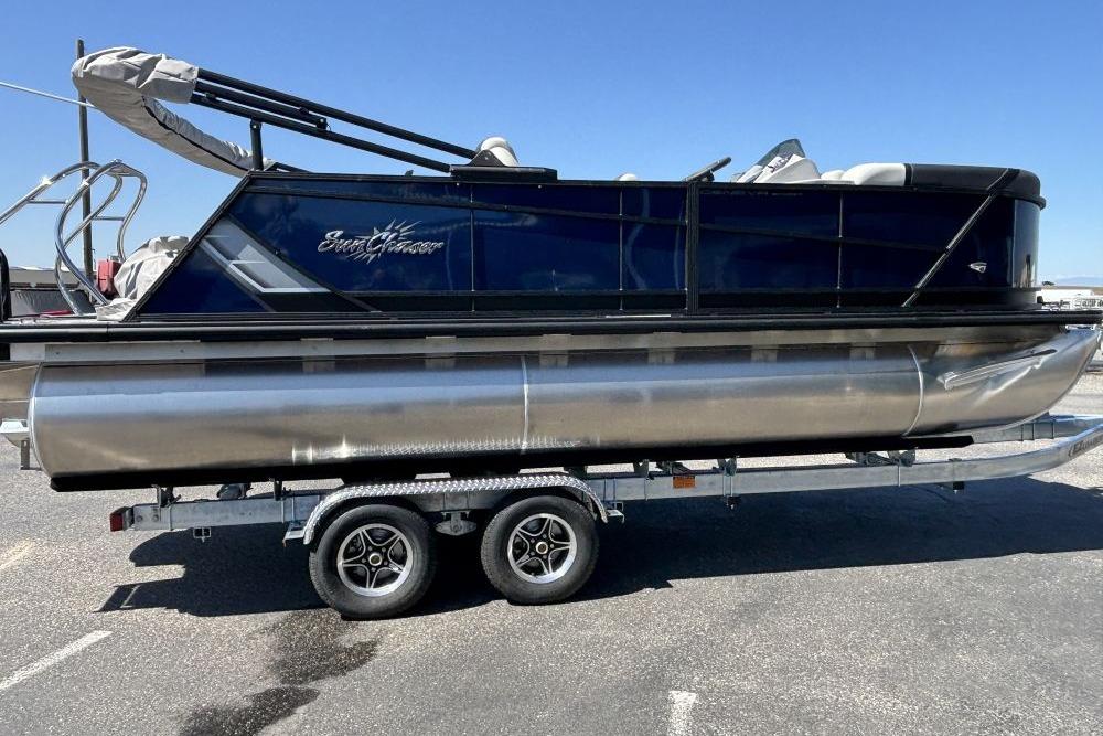 2026 SunChaser Geneva Sport 21 SB DH pontoon boat on trailer, side view.