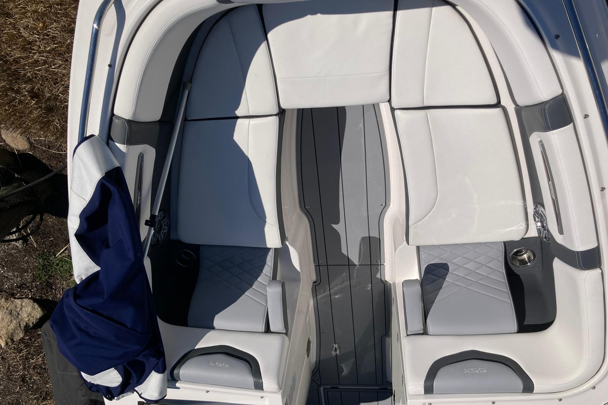 2022 Chaparral 267 SSX OB boat interior with white and gray seating.