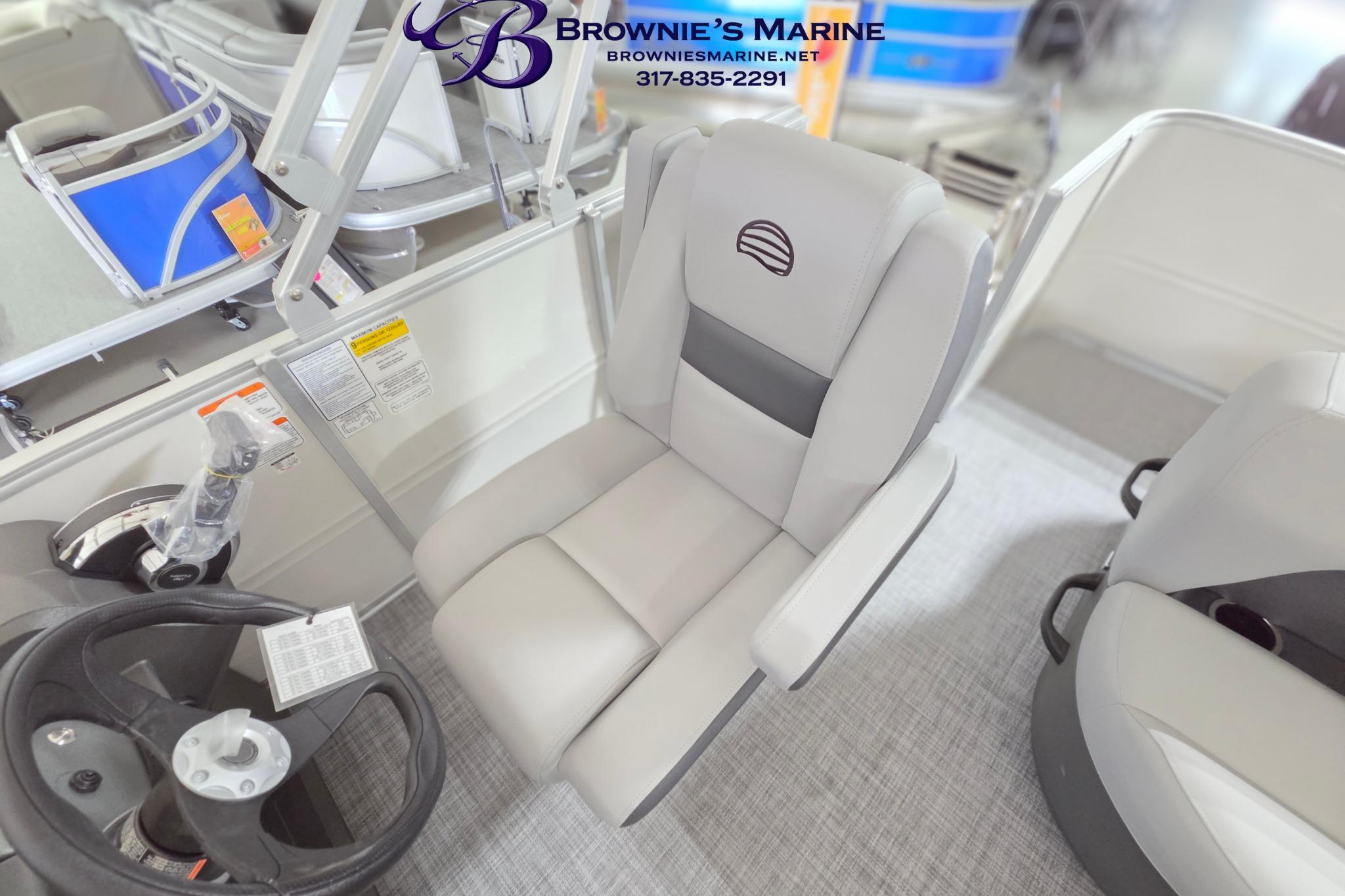 2026 Sun Tracker Party Barge 18 DLX interior with steering wheel and captain's chair.