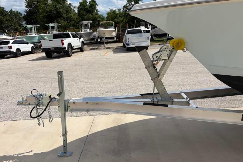 2024 Key West 239 FS boat on trailer in parking lot with trucks and boats.