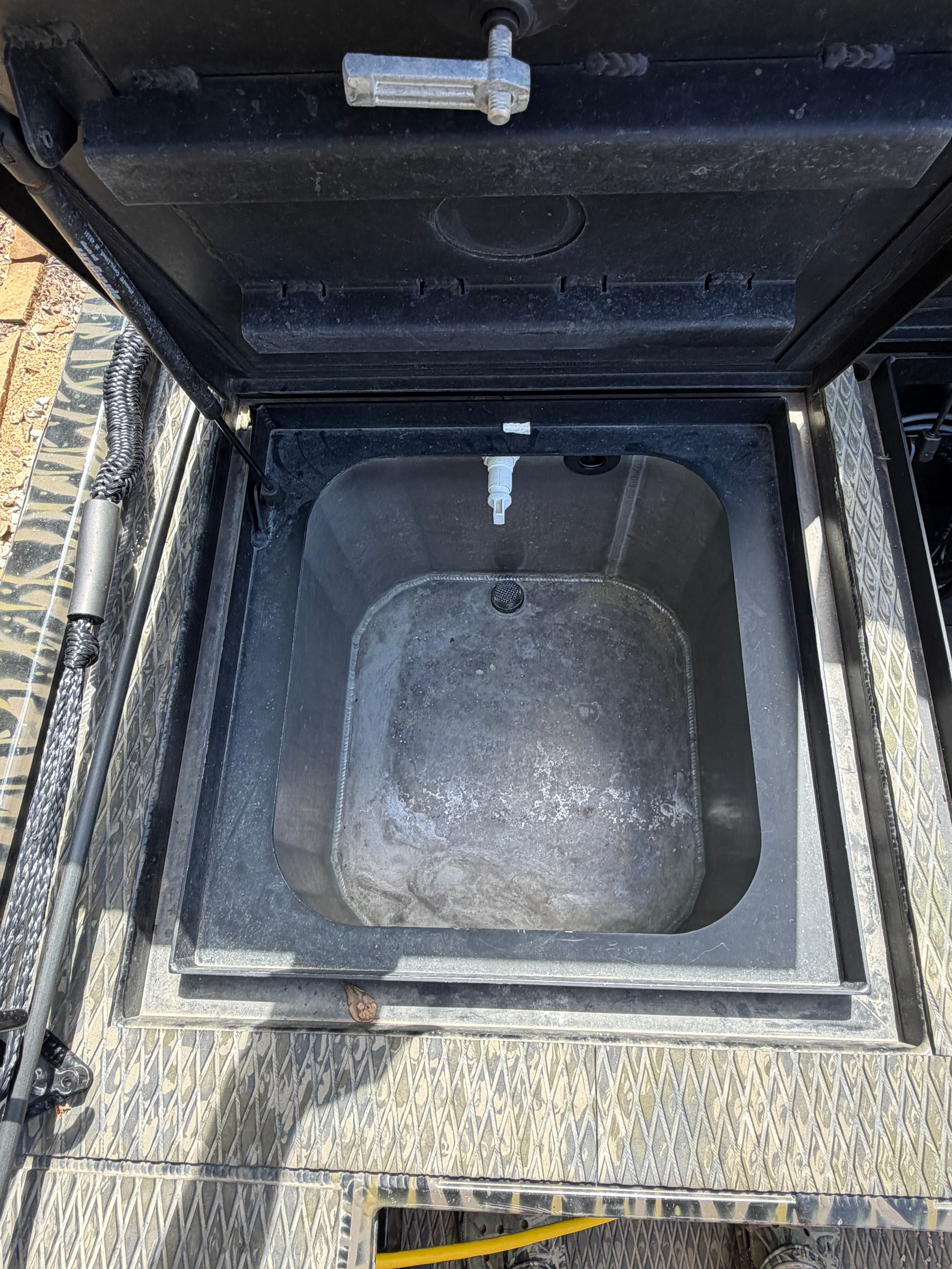 An open storage compartment on a 2023 Prodigy 1860 boat.