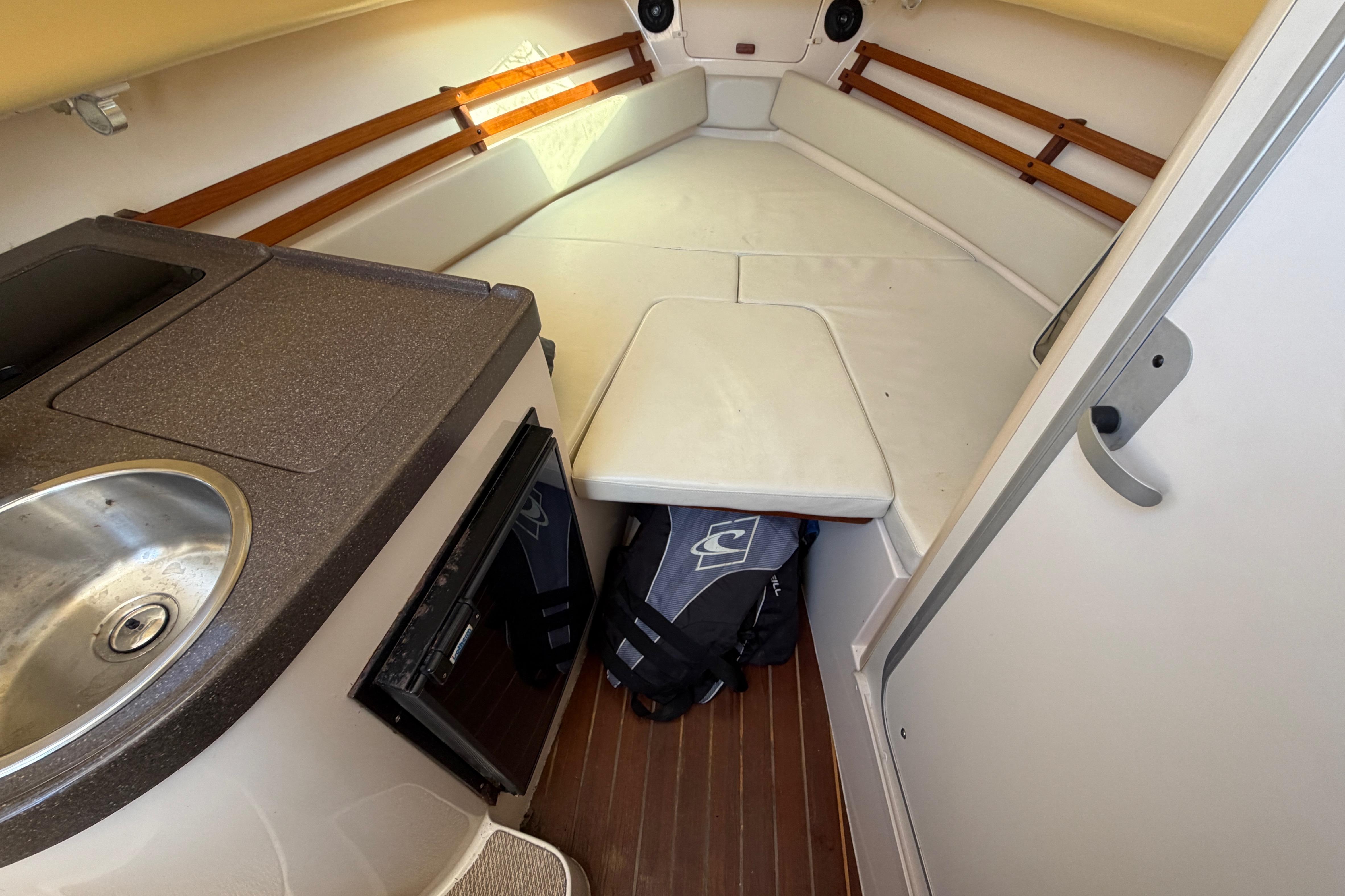 Interior cabin of 2006 Grady-White Sailfish 282 with kitchenette and seating area.