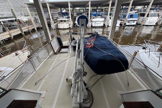 1986 Krogen 42 Classic yacht docked in a marina, surrounded by other boats.