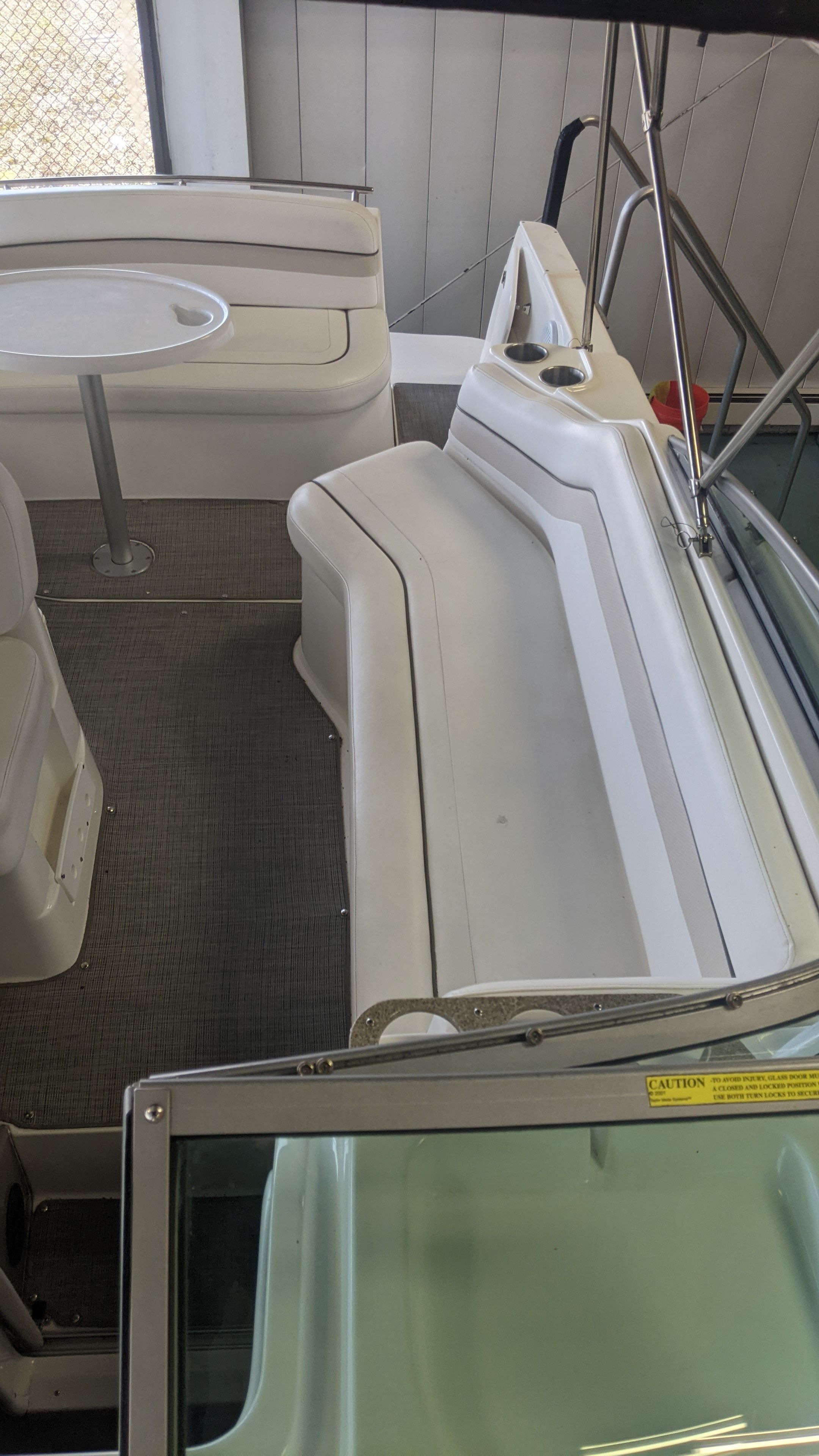 Interior of a 2006 Rinker 250 EC boat with seating area.
