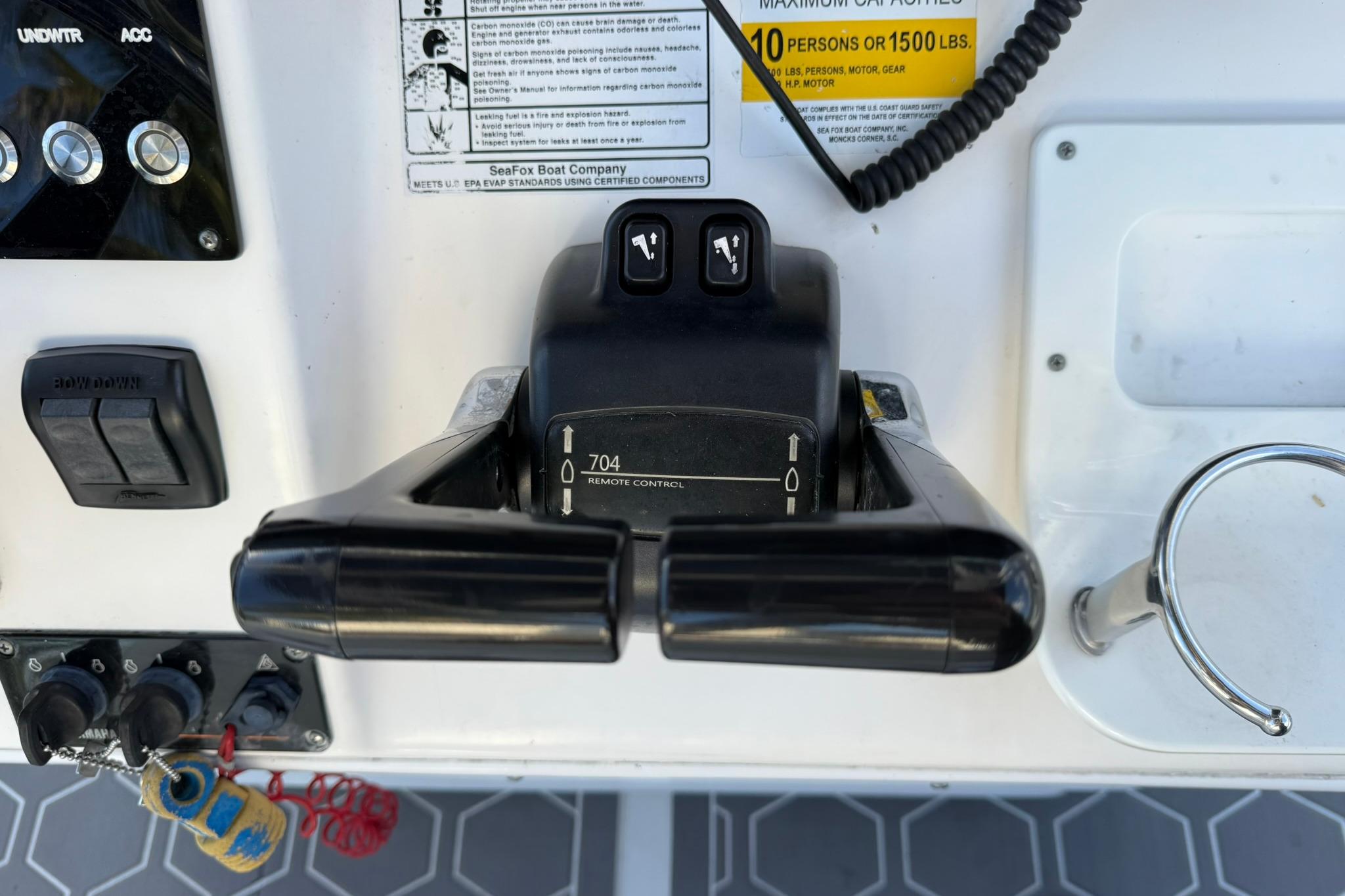 Control panel of a 2014 Sea Fox 256 Commander boat with throttle and switches.