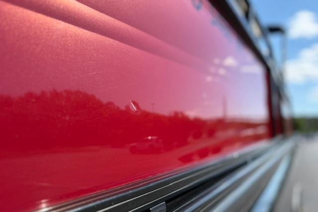 Close-up of shiny red exterior on 2025 Regency 250 DL3 boat.