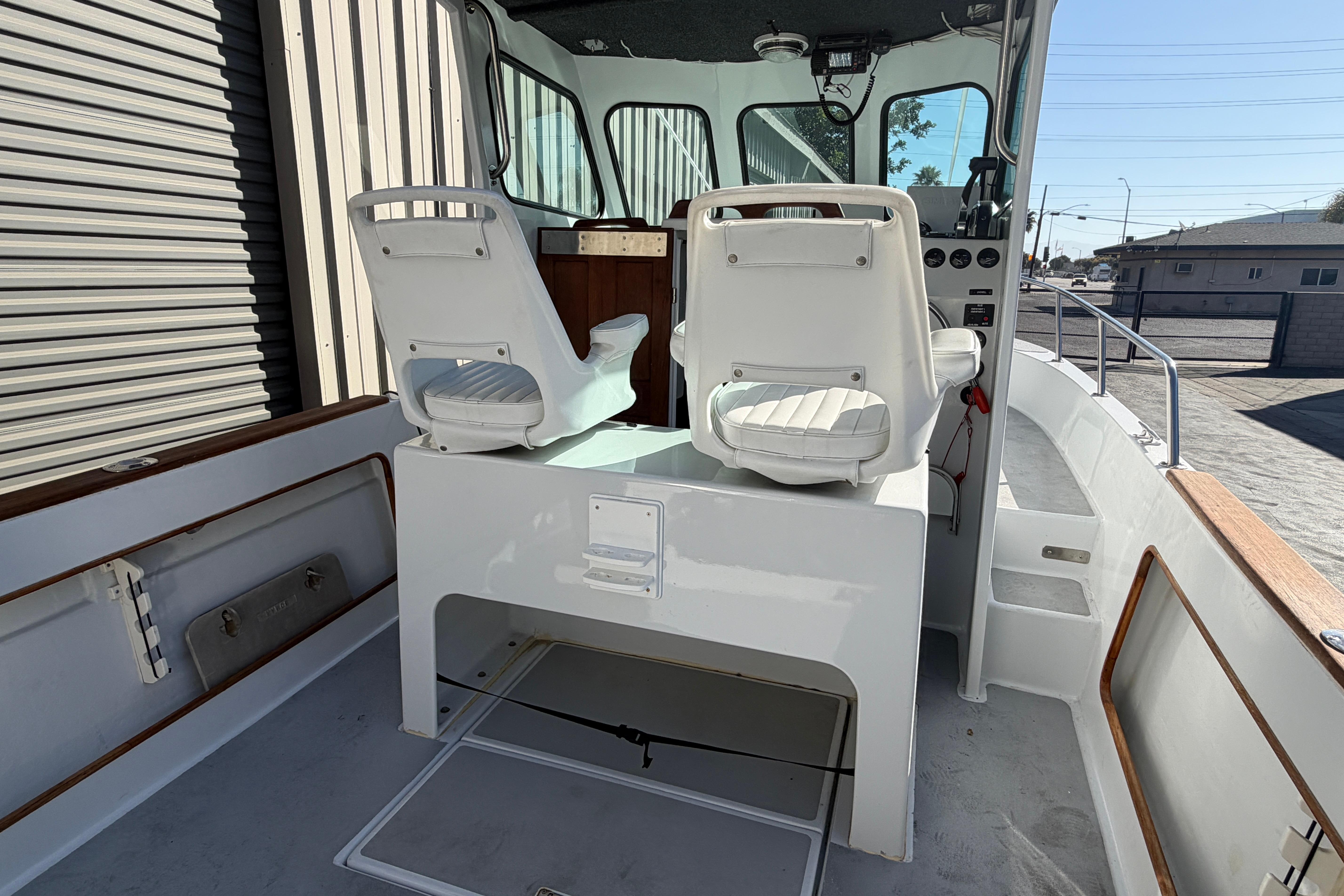 1986 Radon 21 Sport boat interior with white seating and control panel.