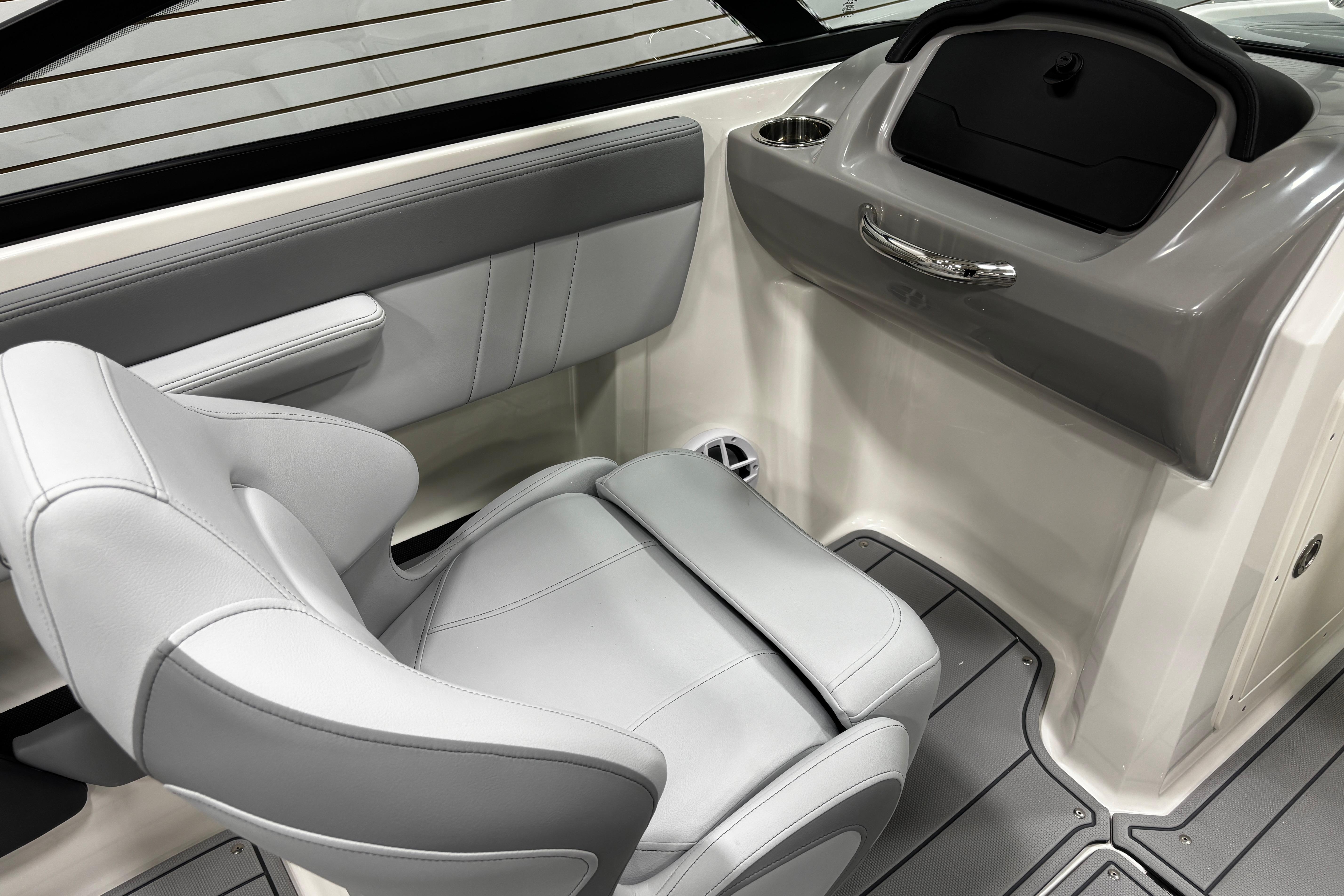 2026 Chaparral 21 SSi boat interior with gray seating and dashboard.