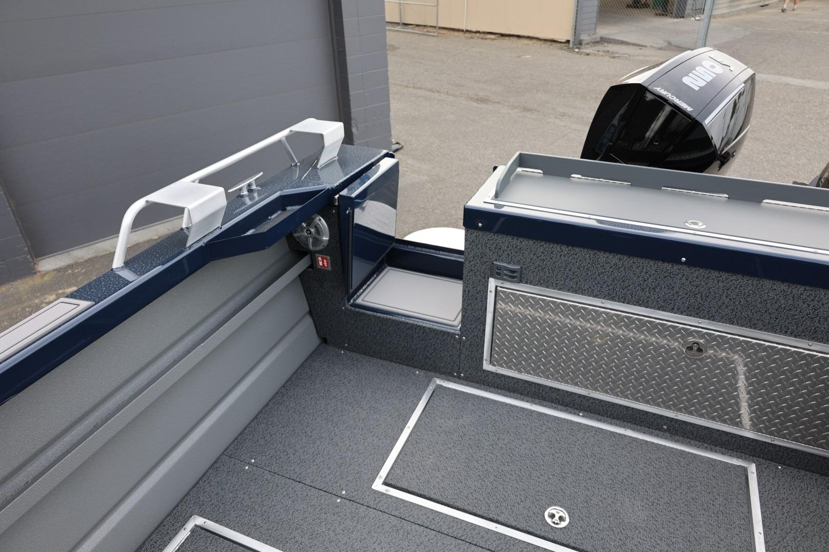2026 Thunder Jet 24 Alexis Pro boat interior with storage compartments and motor view.
